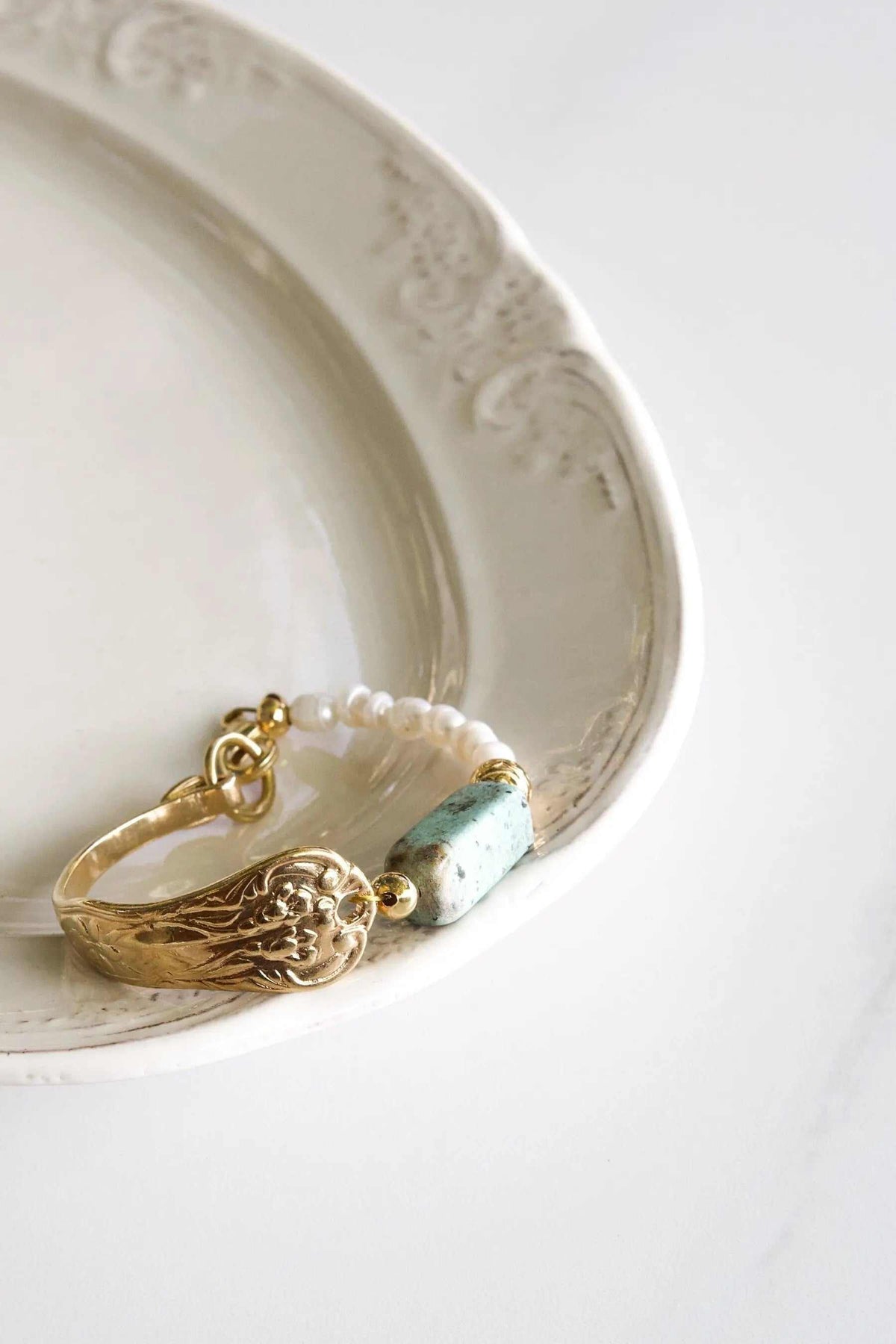 Freshwater Pearl bracelet with ivory beads, pale green spotted stone and ornate gold-tone oval charm