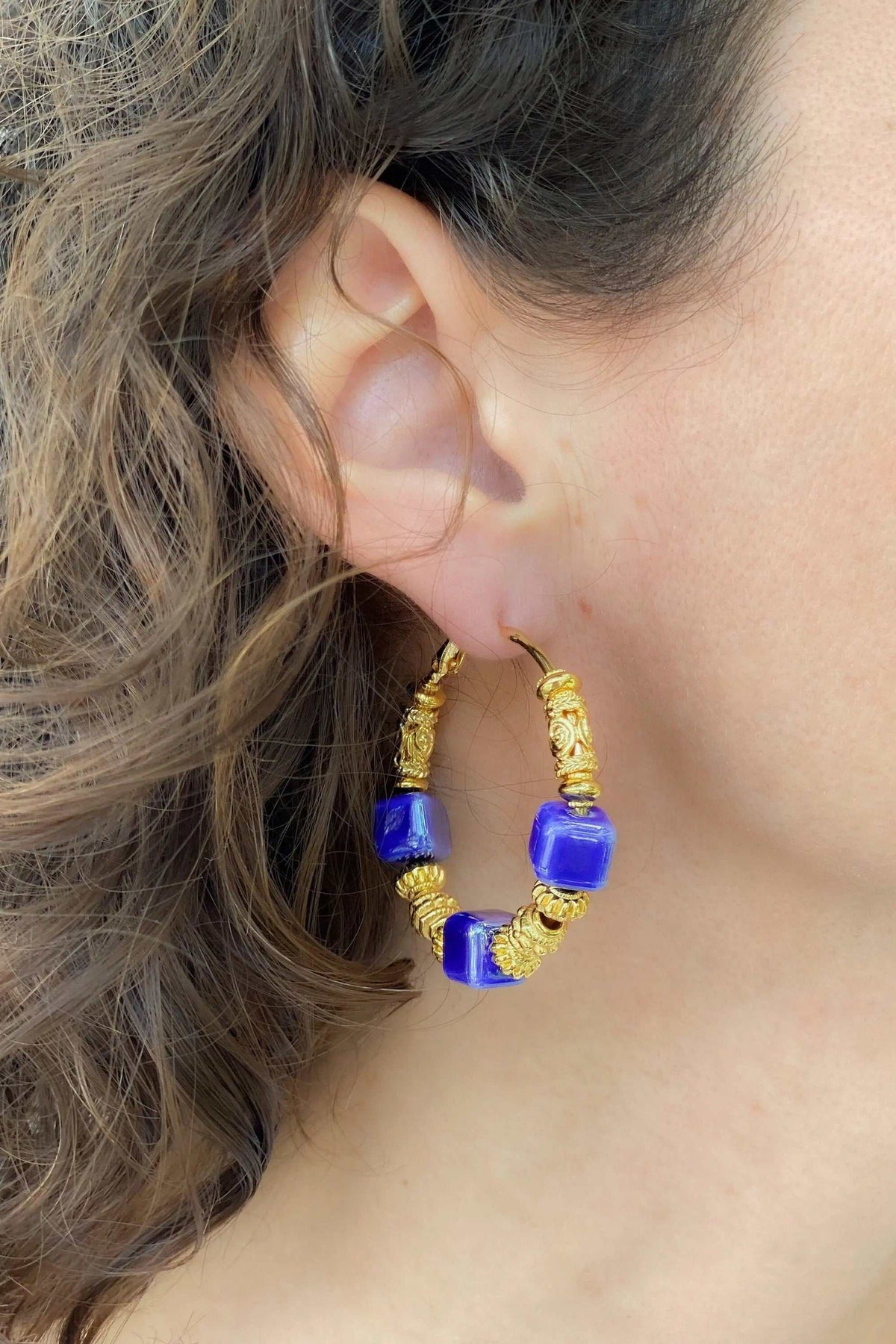 GÉA EARRINGS, gold-plated brass hoops with vivid blue ceramic cube beads and textured detailing