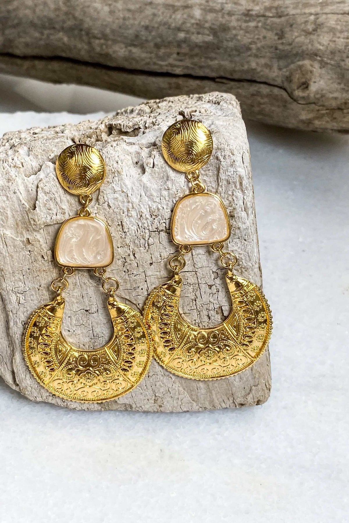 Gold Boho earrings with ornate gold-tone crescent drops, round embossed studs, and pale peach resin accents
