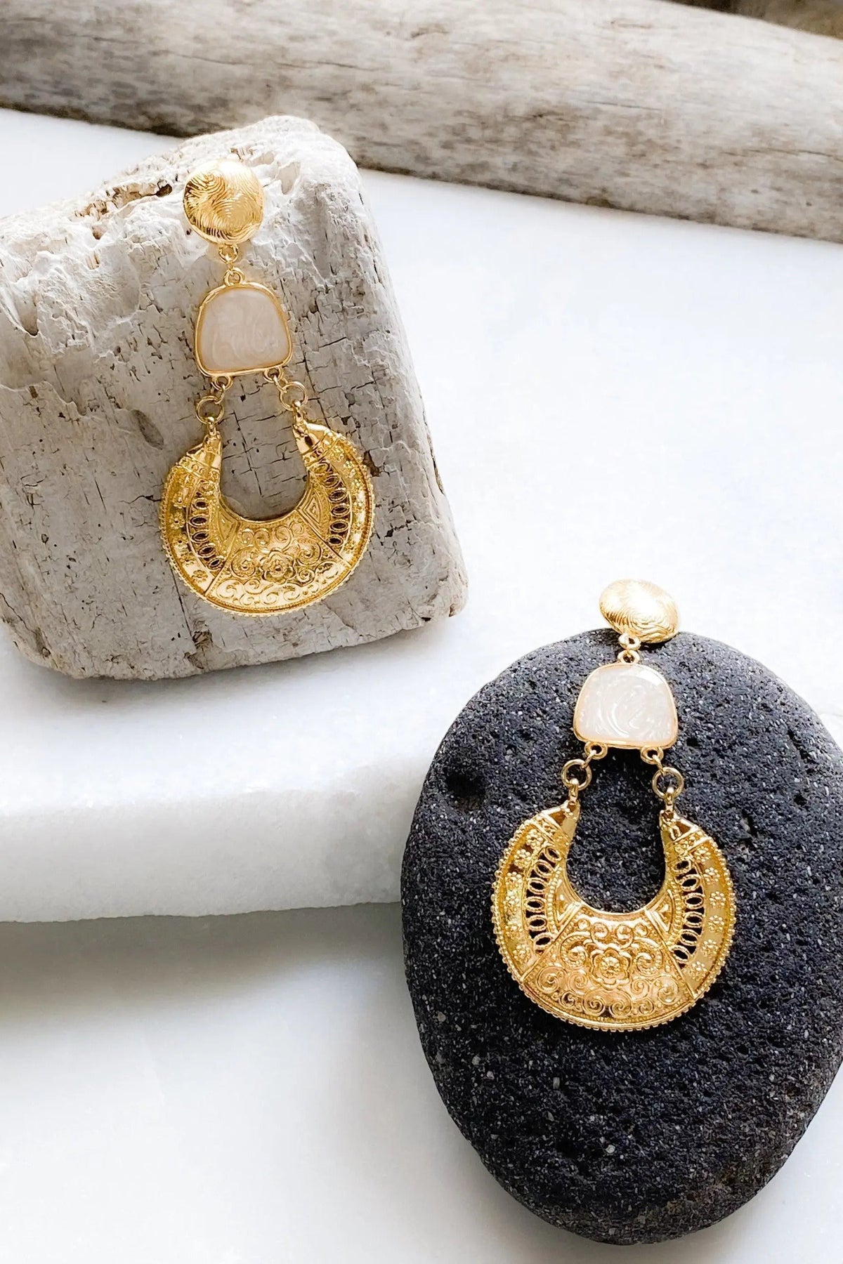 Gold Boho earrings with ornate gold-tone filigree crescent drops, pale blush resin accents and round stud tops