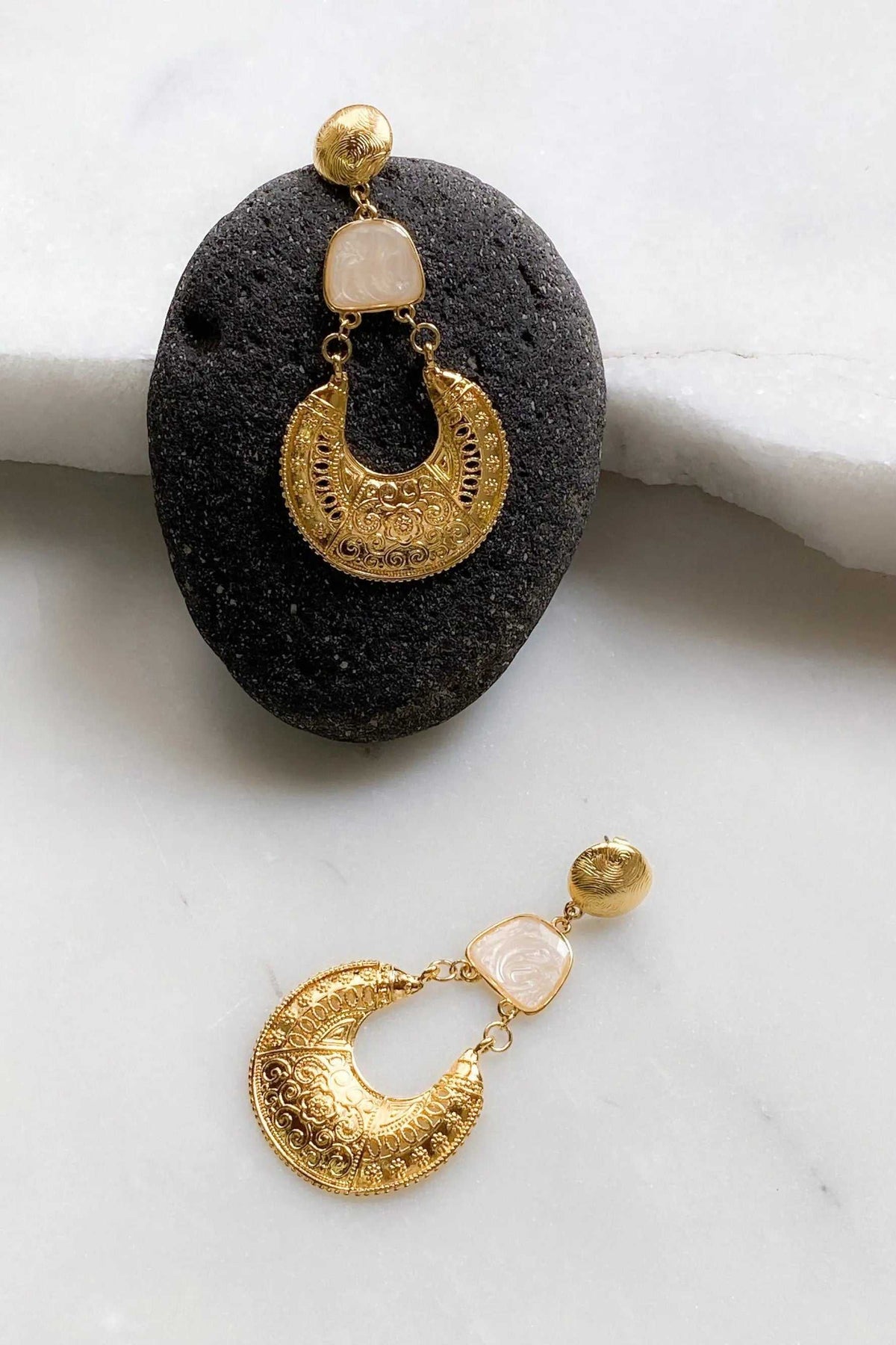 Gold Boho earrings with ornate gold crescent-shaped filigree drops, pale pink stones, and round gold studs