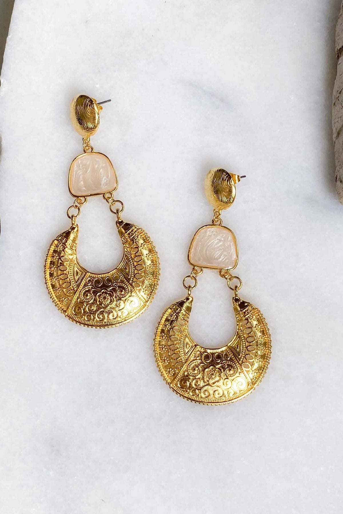 Gold Boho earrings with ornate gold-tone crescent drops, pale pink rectangular stones and engraved floral details