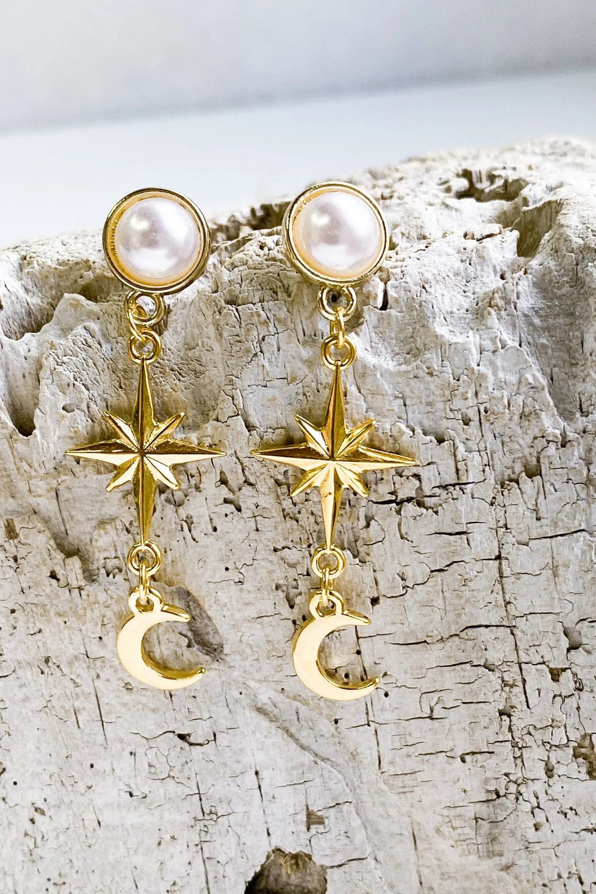 Gold celestial Earrings with round white pearl studs, gold-tone metal, starburst charms and dangling crescent moons