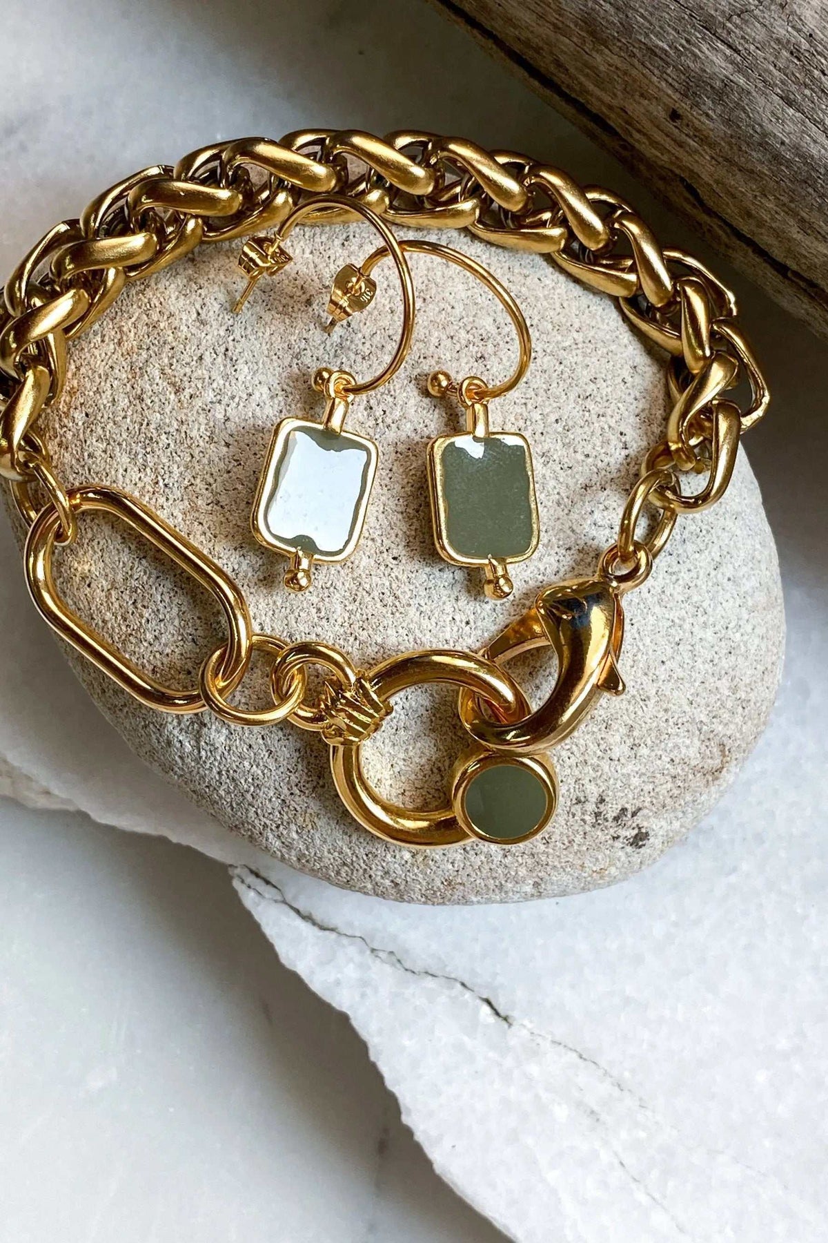Gold Chain bracelet in chunky polished gold-tone links with a rounded green charm clasp, paired with matching earrings