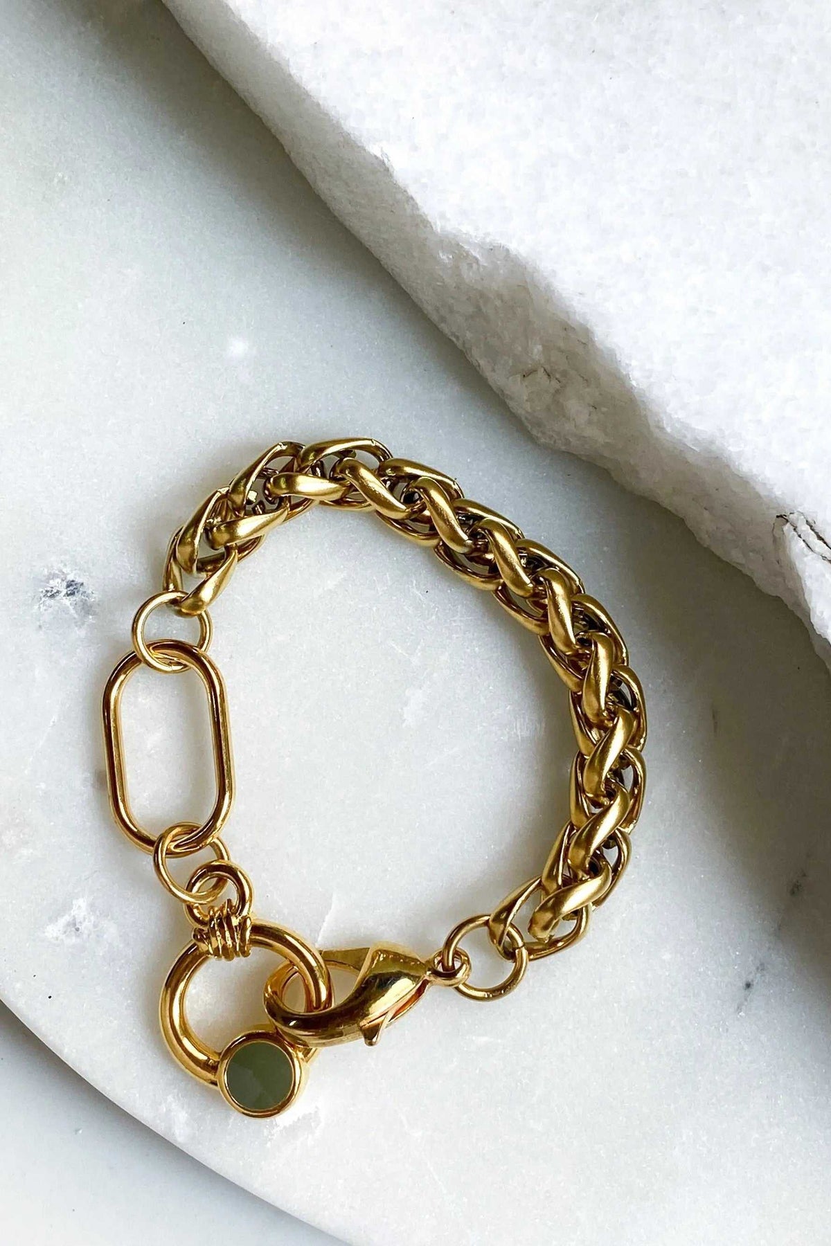Gold Chain bracelet in polished gold-tone metal with chunky interlocking links, a round green charm and oversized clasp