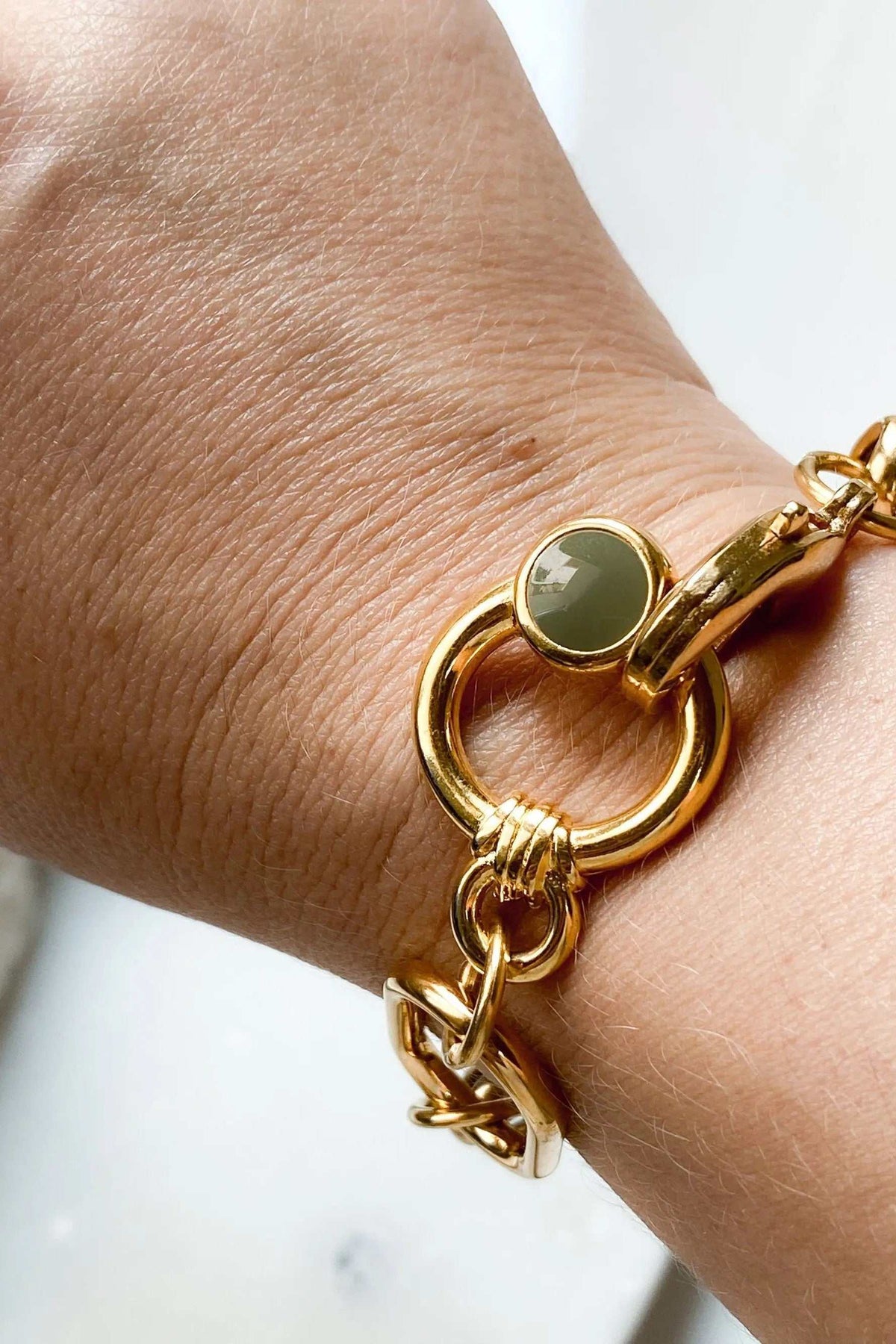 Gold Chain bracelet with chunky polished gold-tone links and a round green charm clasp in a vintage style