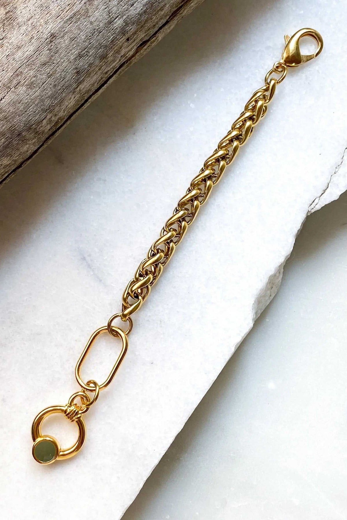 Gold Chain bracelet in polished gold-tone metal with chunky woven links, a lobster clasp and green-accented buckle closure