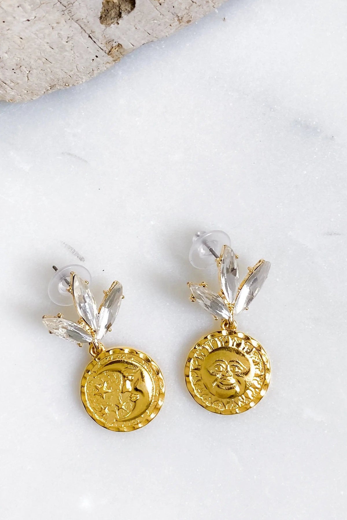 Gold Coin drop Earrings in gold with embossed sun and moon coin charms, clear crystal leaf studs and dangling design