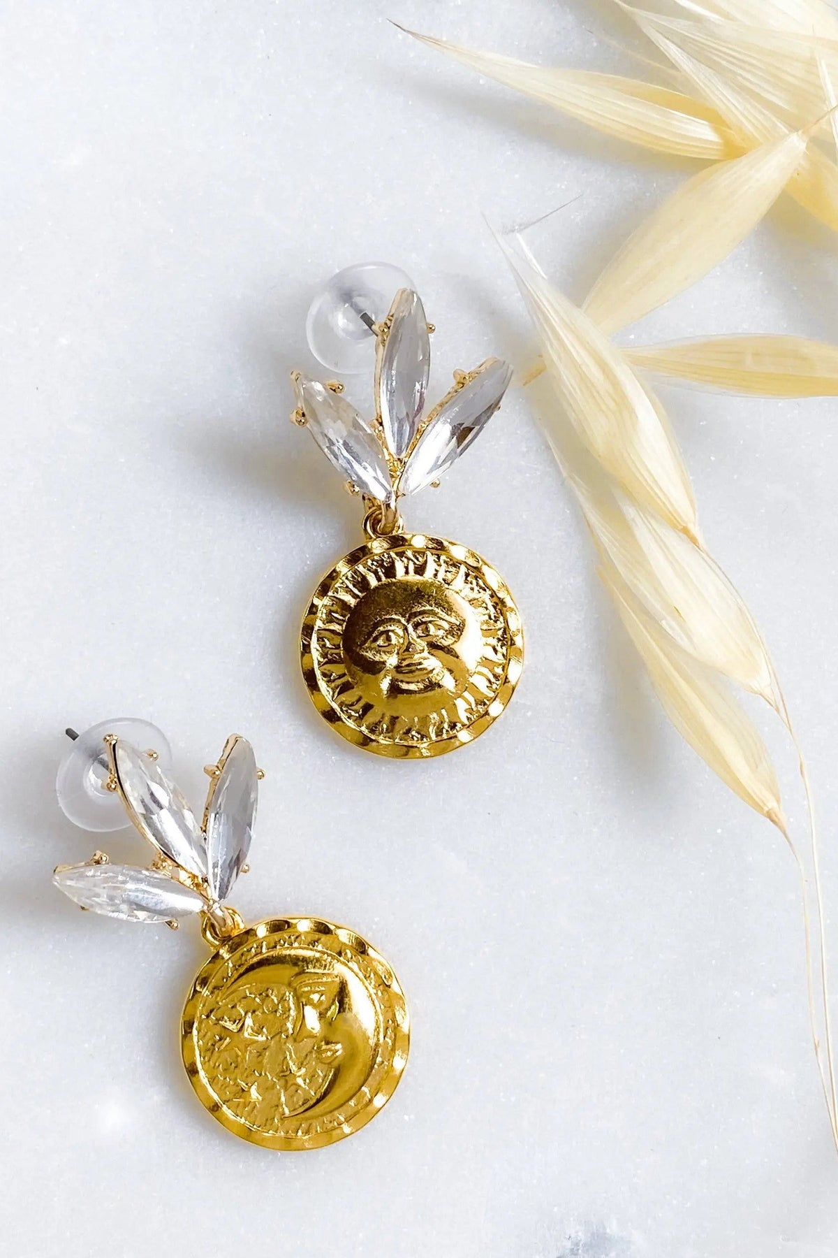Gold Coin drop Earrings in gold-tone metal, with embossed sun and moon coins beneath clear crystal leaf studs