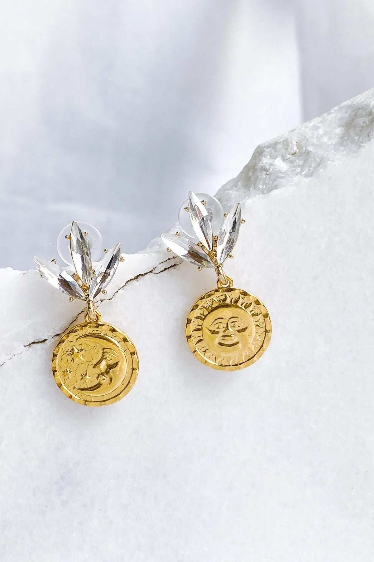Gold Coin drop Earrings with round textured gold-tone coins and clear crystal leaf-shaped stud details.