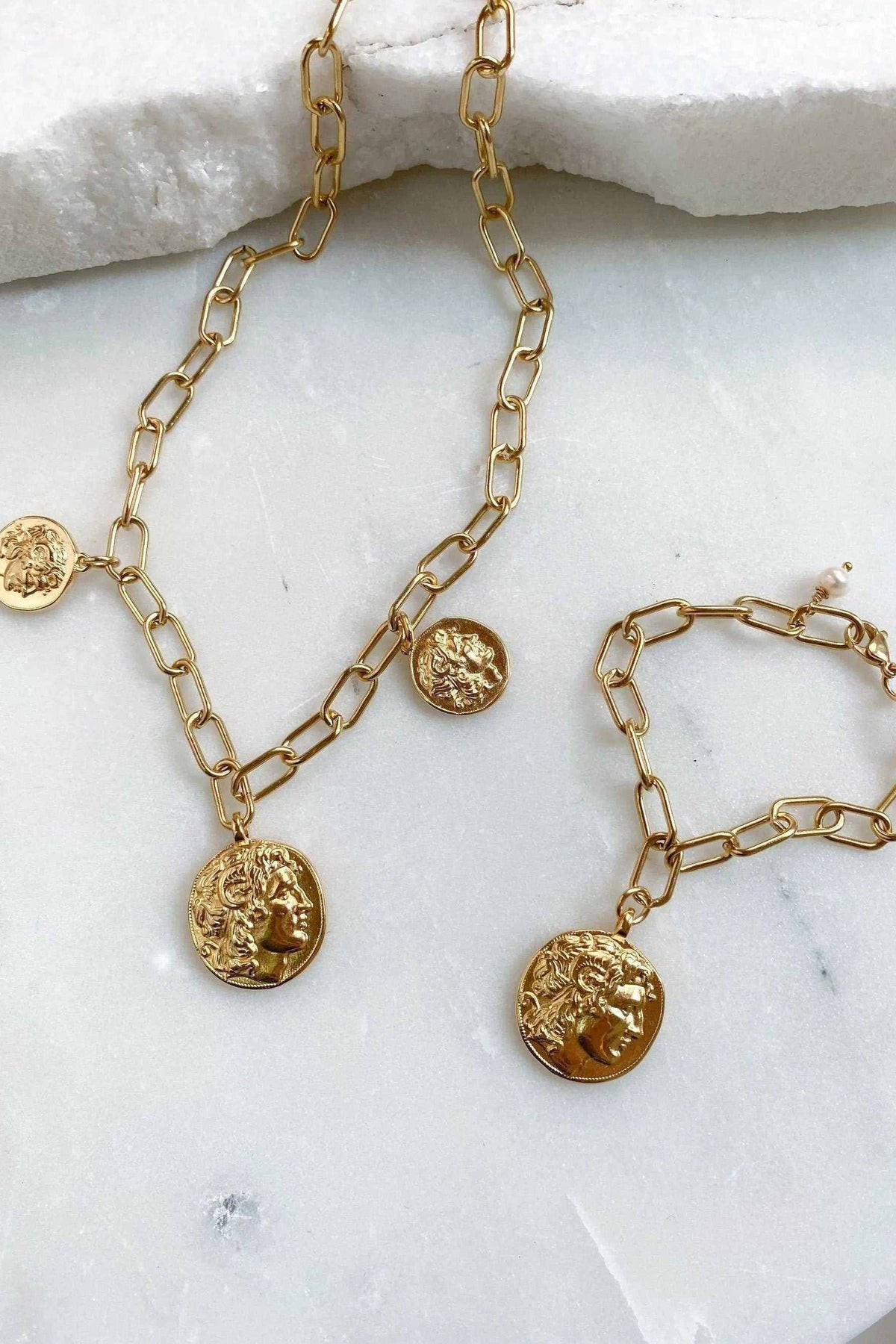 Gold Coin Necklace in gold-toned metal with chunky paperclip chain and round embossed coin pendants