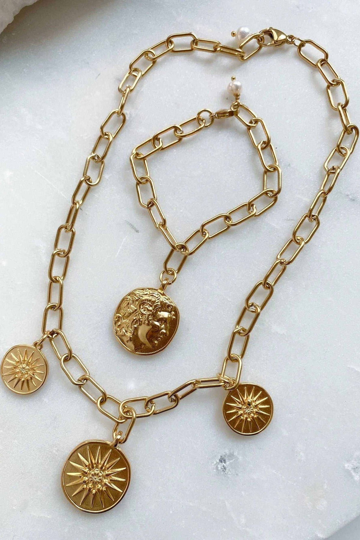 Gold Coin Necklace in gold-tone metal with chunky paperclip chain and four textured coin pendants