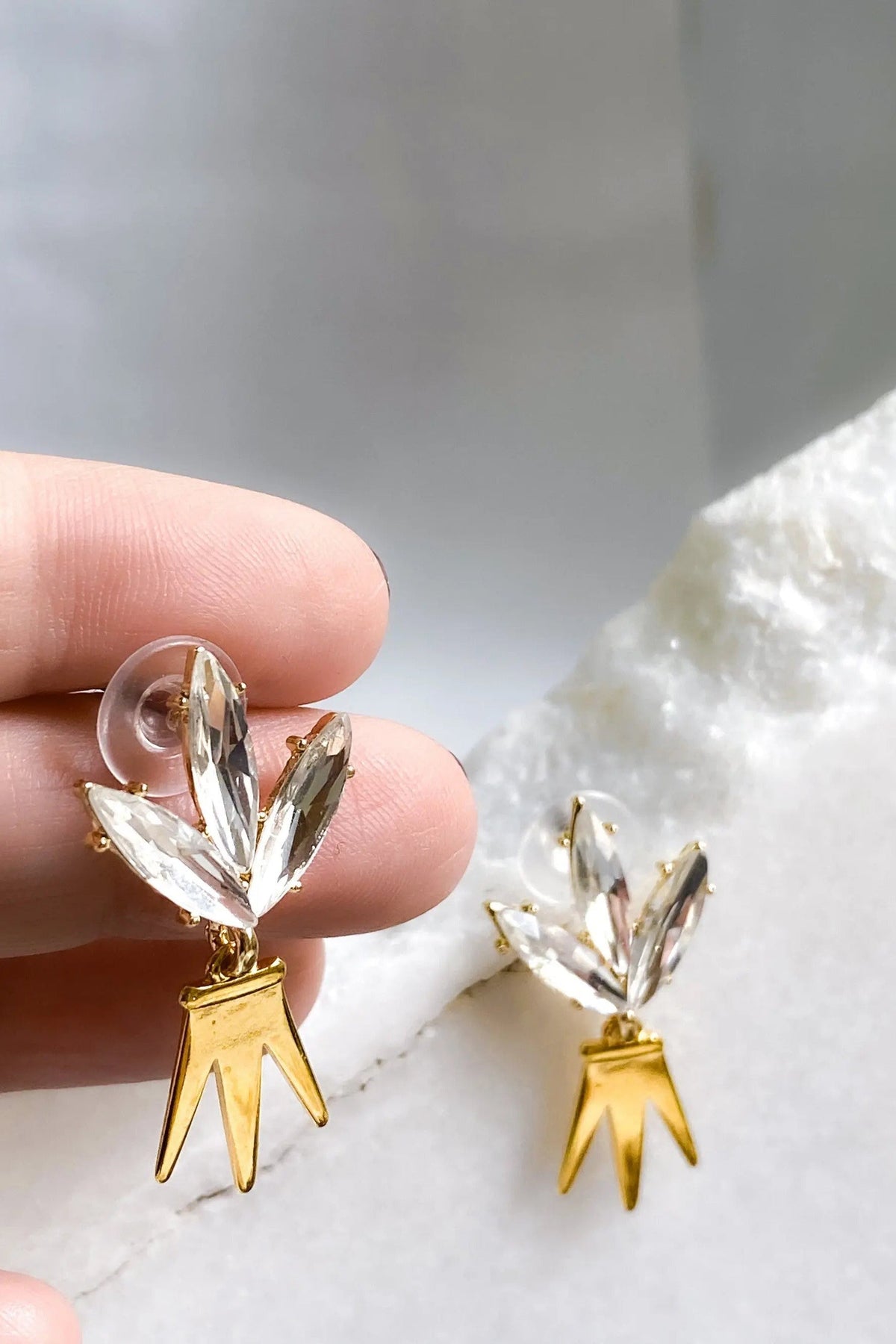 Gold Crown Earrings with gold-tone crown pendants and clear faceted crystal leaf studs in a delicate design