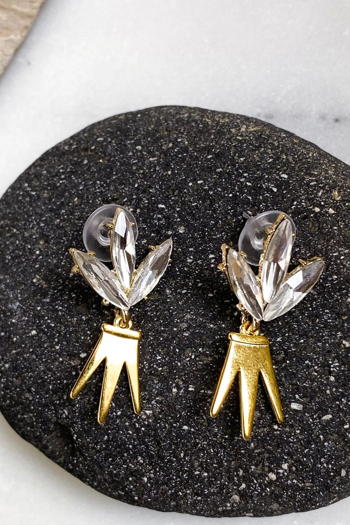 Gold Crown Earrings with clear marquise-cut crystal leaf studs and dangling polished gold crown-shaped charms