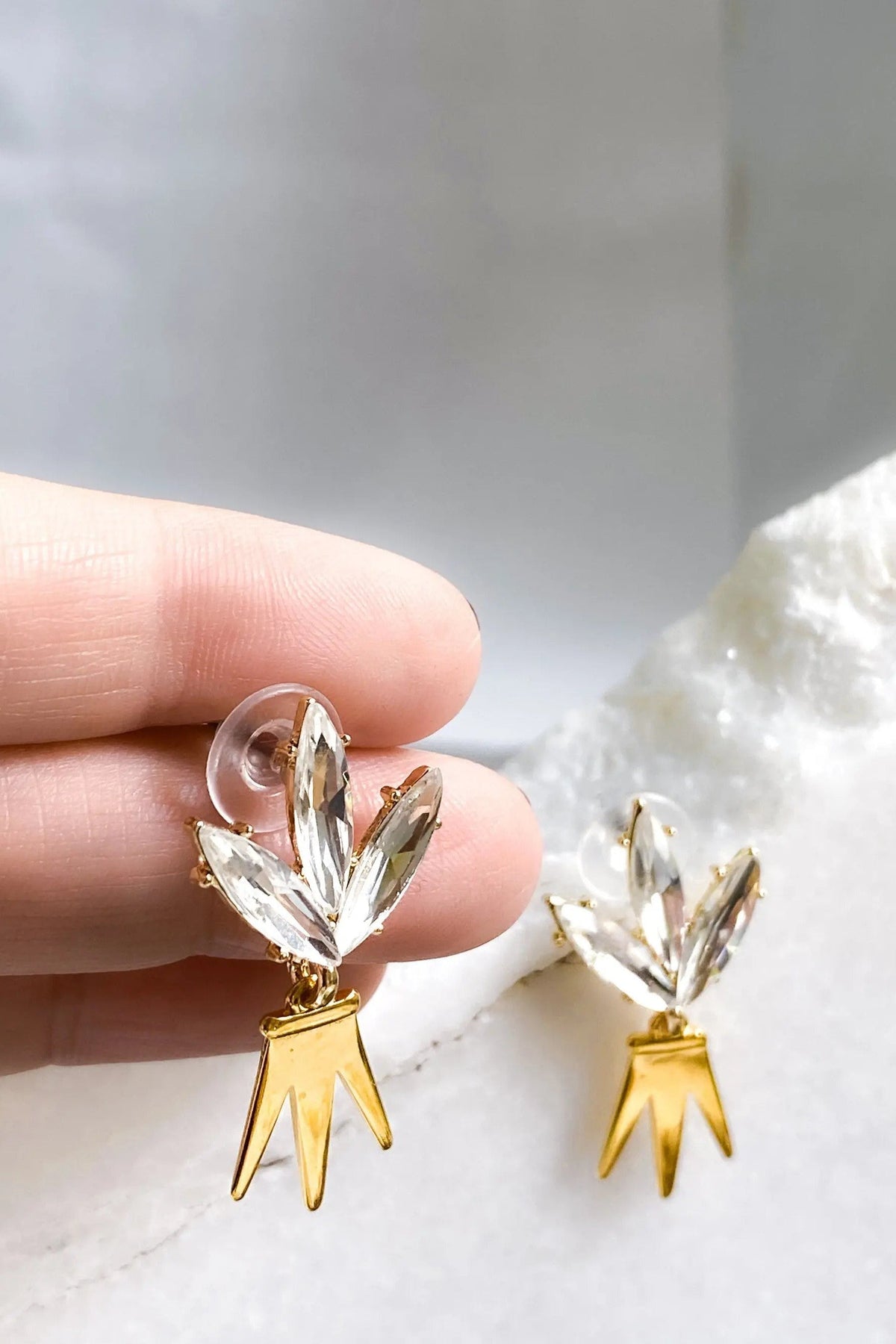 Gold Crown Earrings with polished gold dangling points and clear crystal leaf clusters at the top