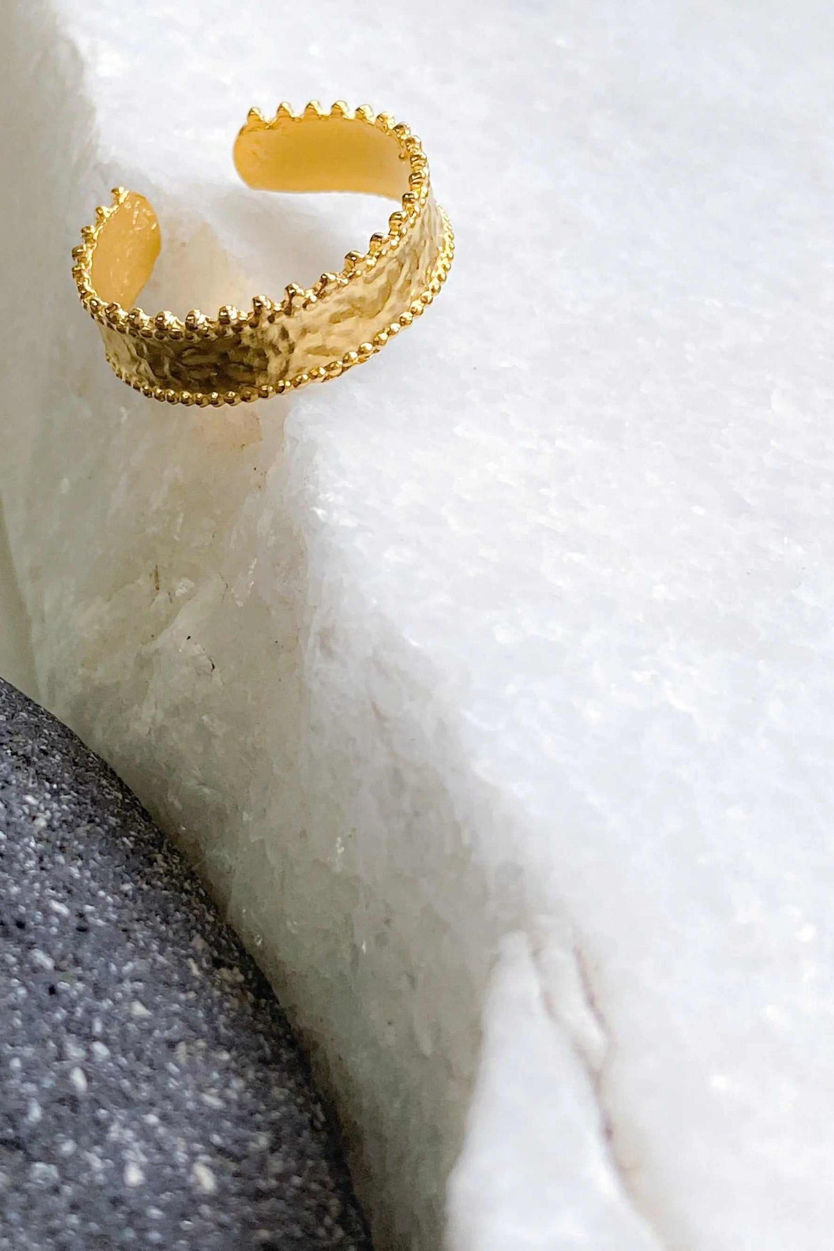 Gold dainty ring in a textured gold-tone finish, with an open adjustable band and decorative scalloped edges