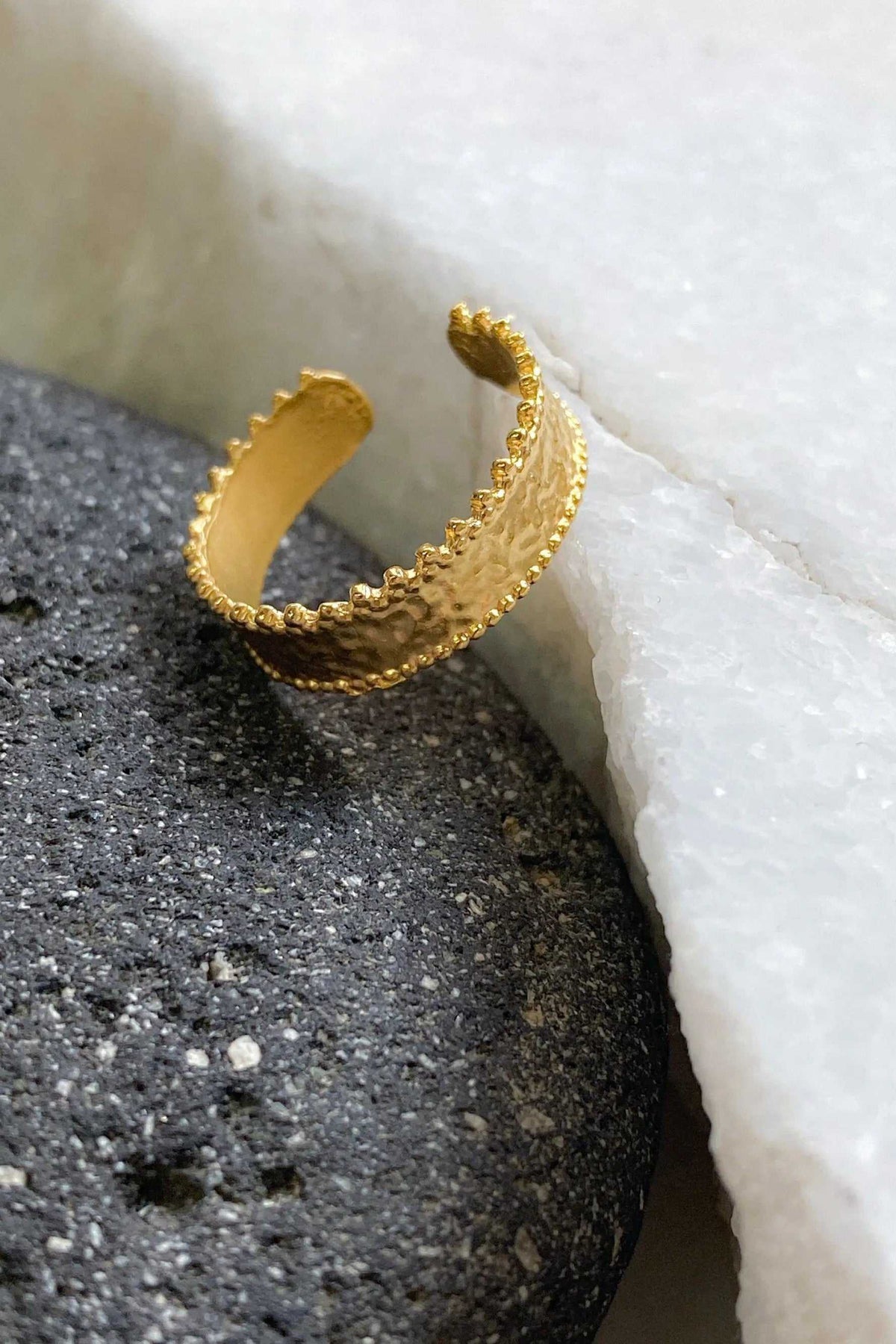 Gold dainty ring with a textured gold finish, open adjustable band and delicate raised lace-like edges