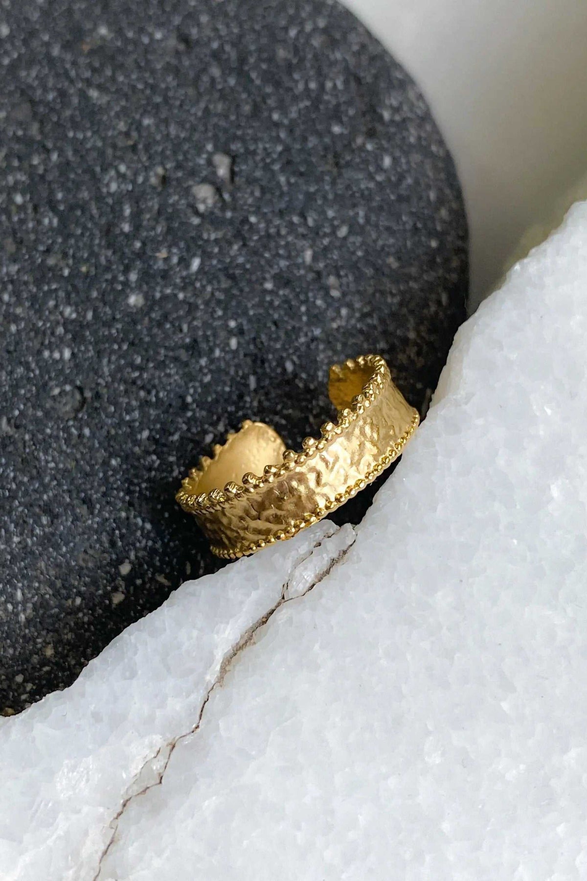 Gold dainty ring with a textured band, scalloped lace-like edges and a slightly adjustable open design