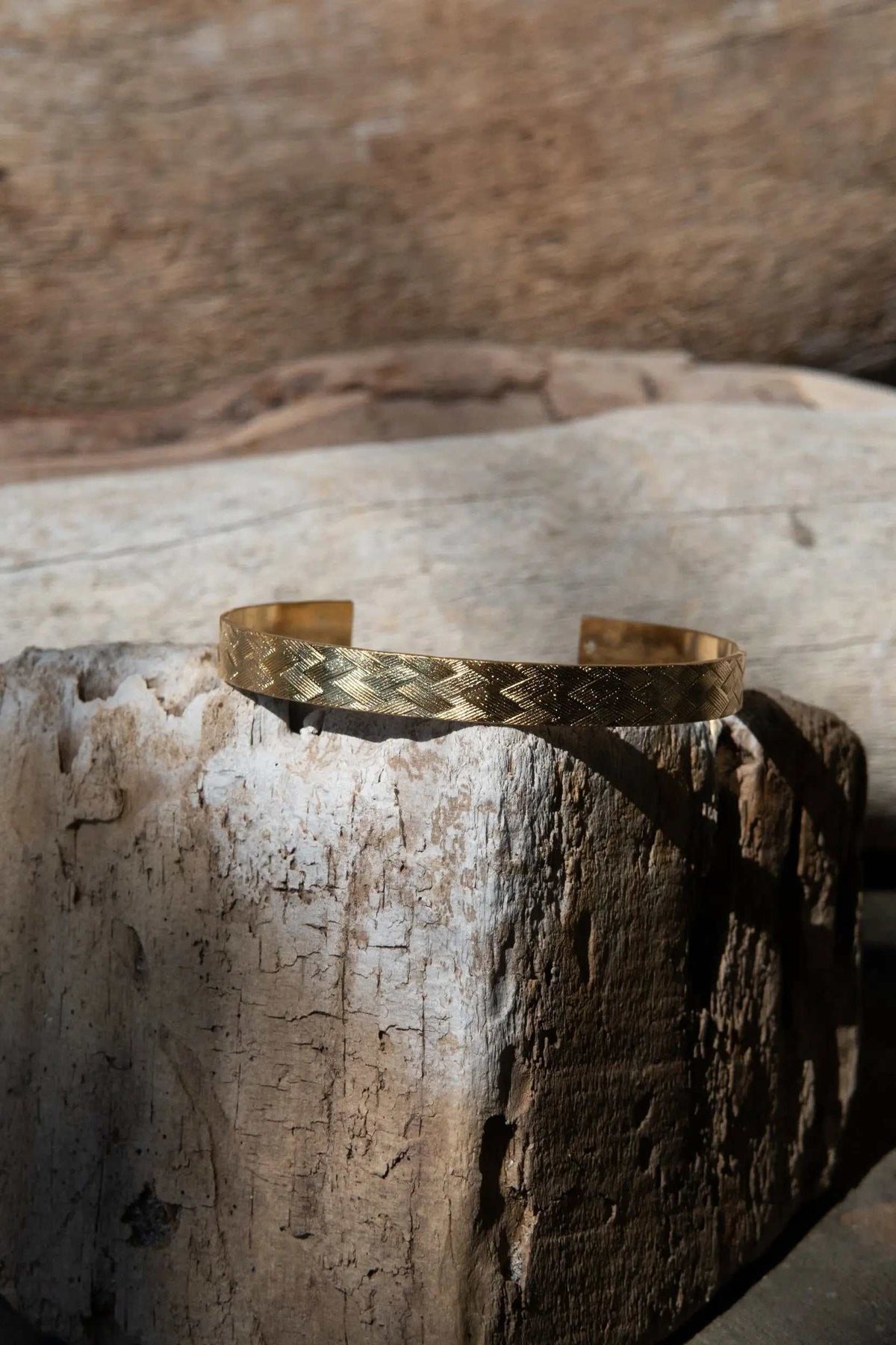 Gold elegant Cuff Bracelet in warm gold tone with a repeating raised geometric straw pattern and open adjustable ends