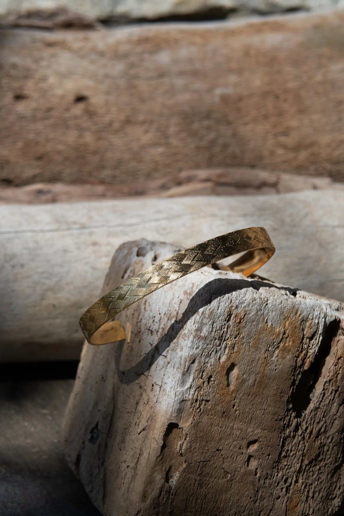 Gold elegant Cuff Bracelet in a warm gold tone with a narrow, textured straw pattern and open cuff design