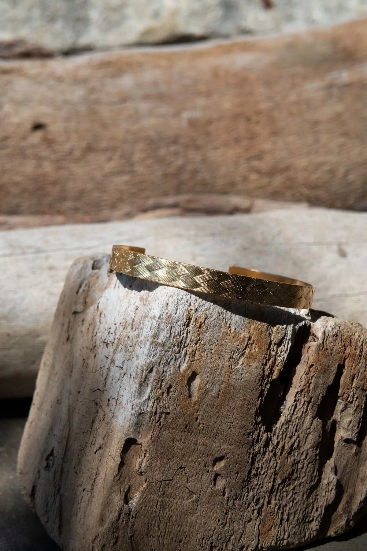 Gold elegant Cuff Bracelet in warm gold metal with a woven straw pattern and an open, slightly adjustable cuff design