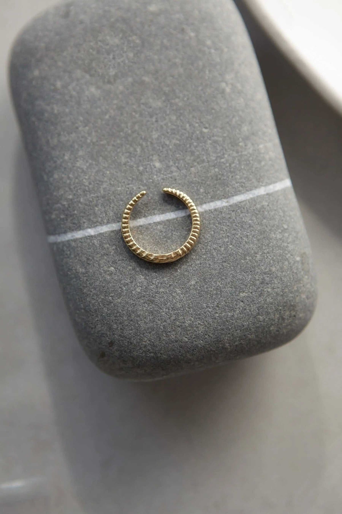 Gold filled band ring in gold tone with a slim open circular band and fine ridged texture