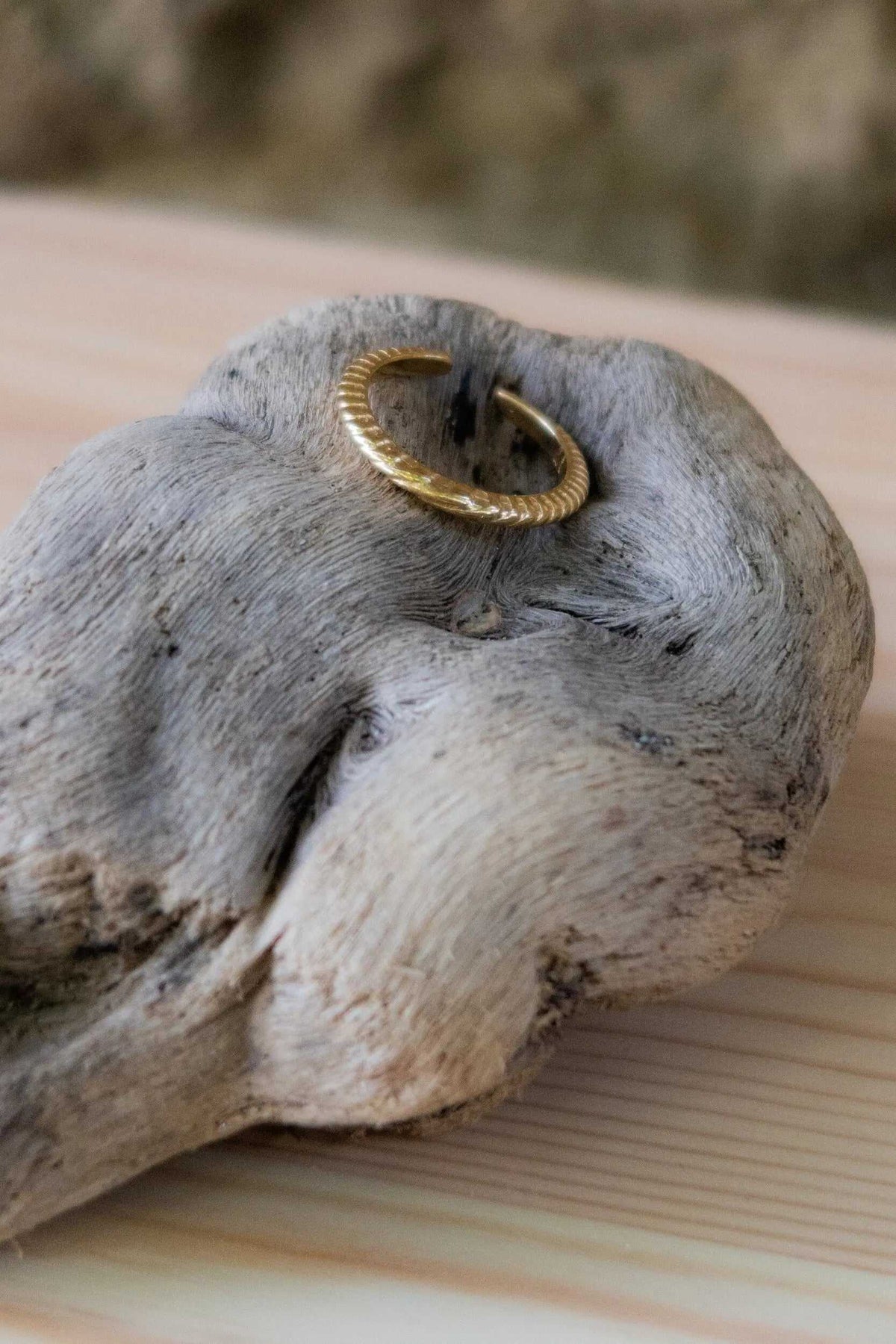 Gold filled band ring with a textured gold-tone surface and open adjustable ends in a slim curved design