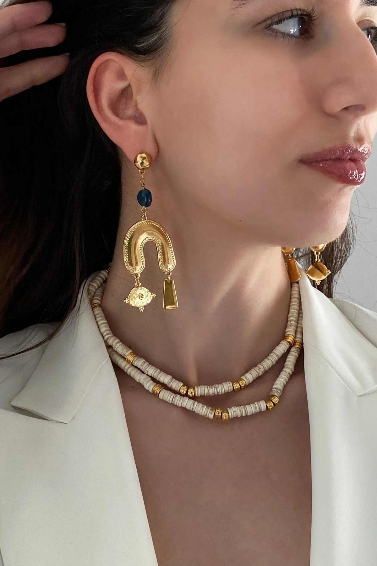 Gold Gypsy Earrings with blue beads and ornate gold-tone horseshoe charms finished with dangling accents