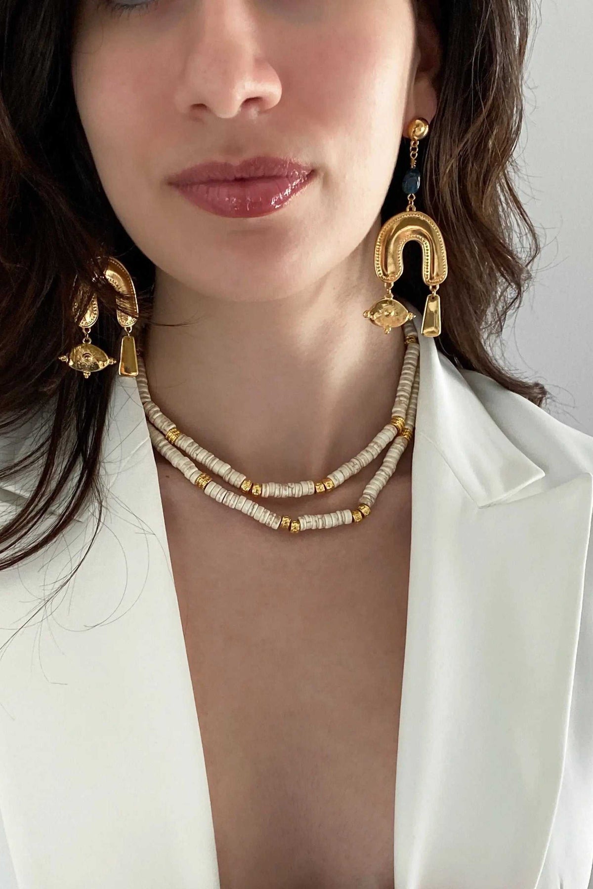 Gold Gypsy Earrings in gold-tone metal with black accents and ornate curved drops, paired with layered beaded necklaces