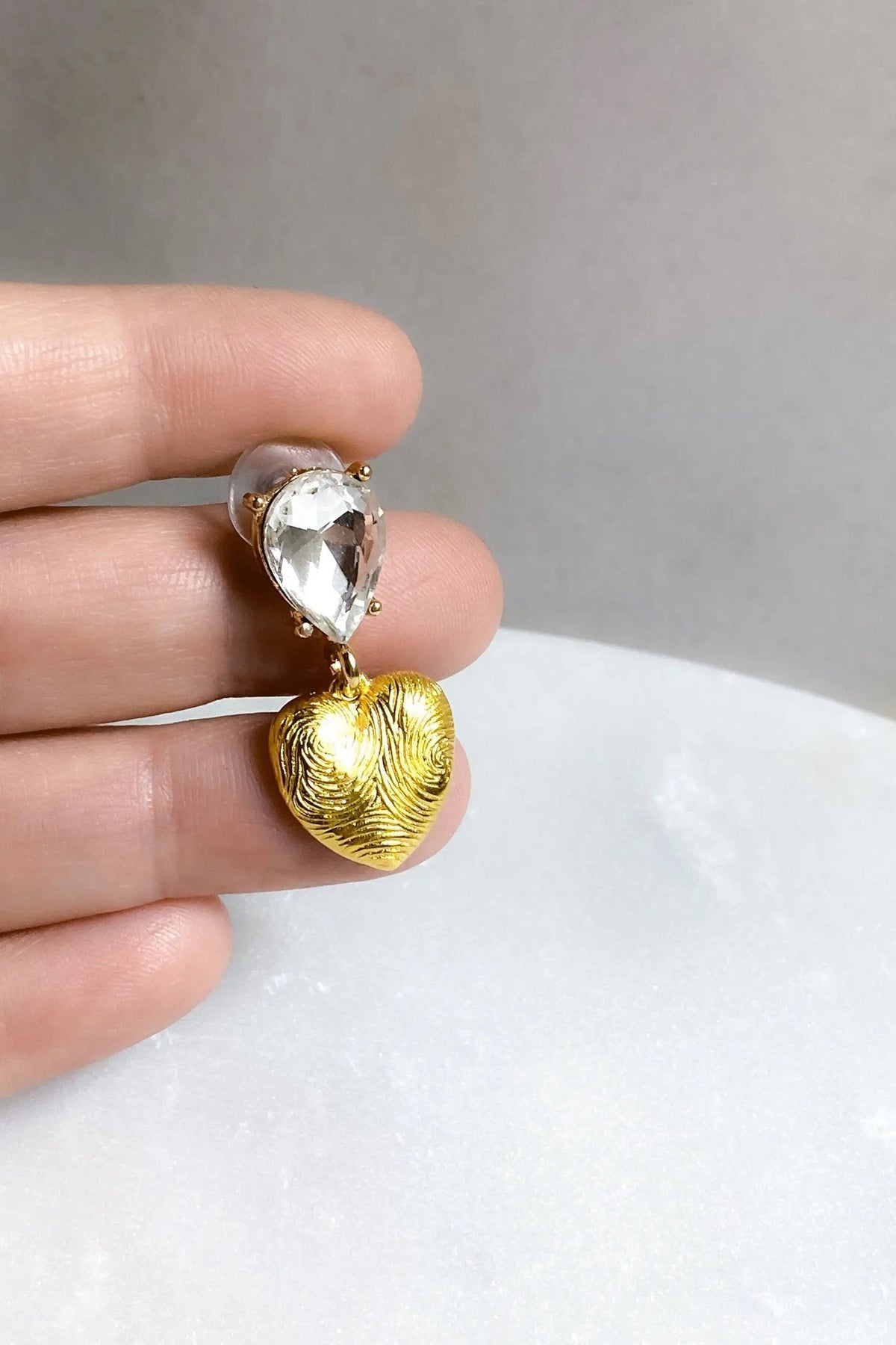 Gold Heart Earrings with textured gold heart drops and clear teardrop crystals in a dangling design