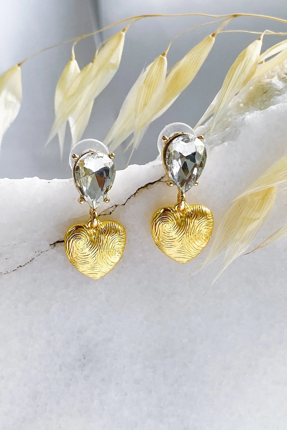 Gold Heart Earrings with textured gold heart charms and clear faceted teardrop crystals in a dangling design