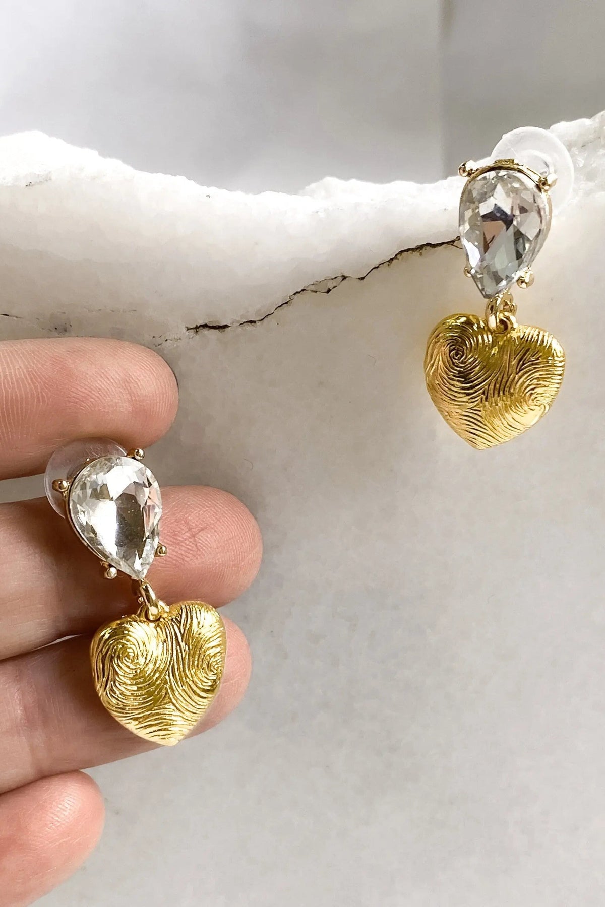 Gold Heart Earrings with textured gold heart charms and large clear faceted teardrop crystals above