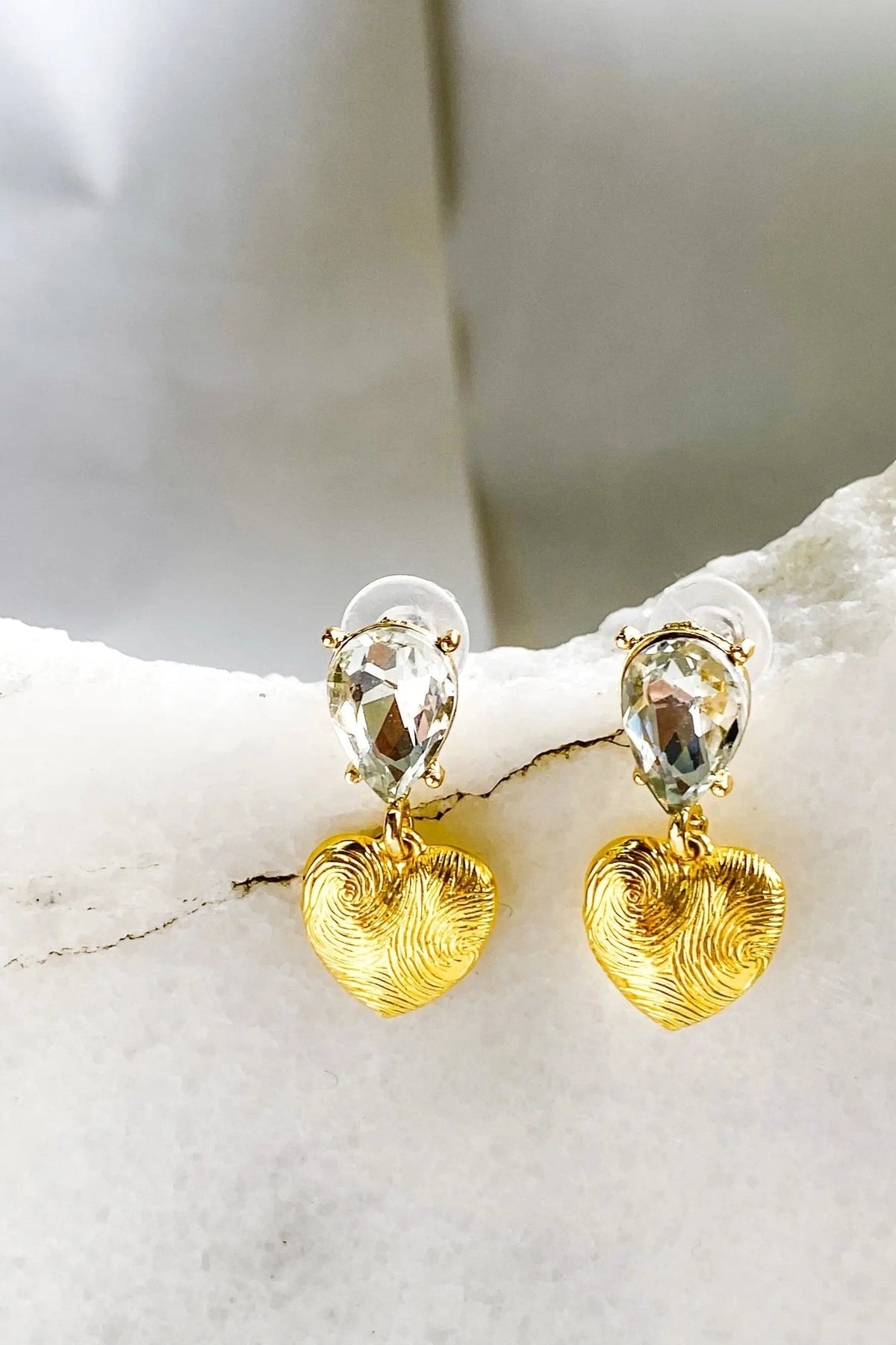 Gold Heart Earrings with textured gold heart drops and clear faceted teardrop crystals in gold-tone settings