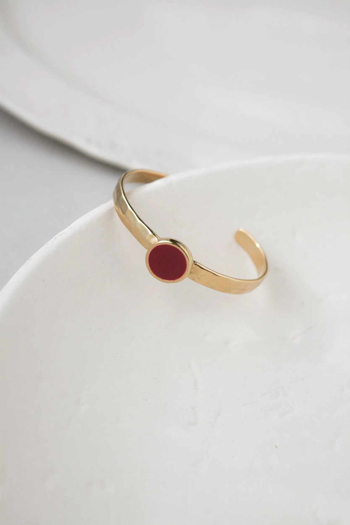 Gold plated Hammered bracelet with a slim gold-tone open cuff and a circular burgundy enamel centerpiece