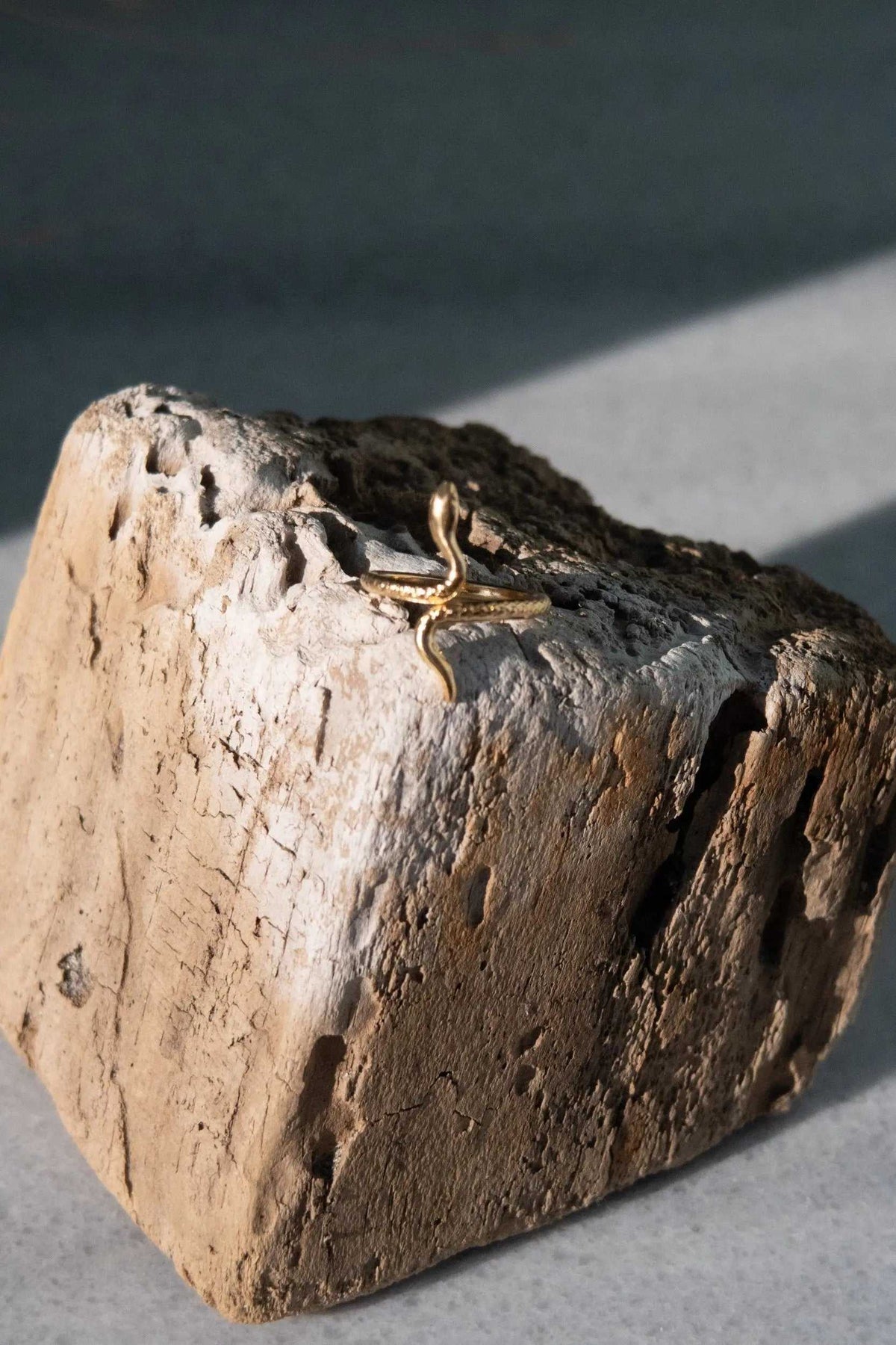 Gold Snake RING with a slender polished gold-tone serpent design, its curved body and raised head forming an open band