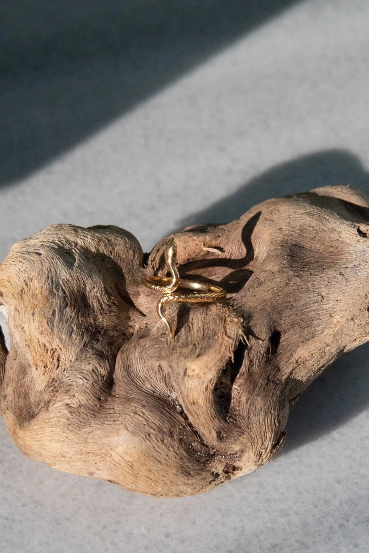 Gold Snake RING in polished gold-tone metal, featuring a slender serpent design with a curved head and body