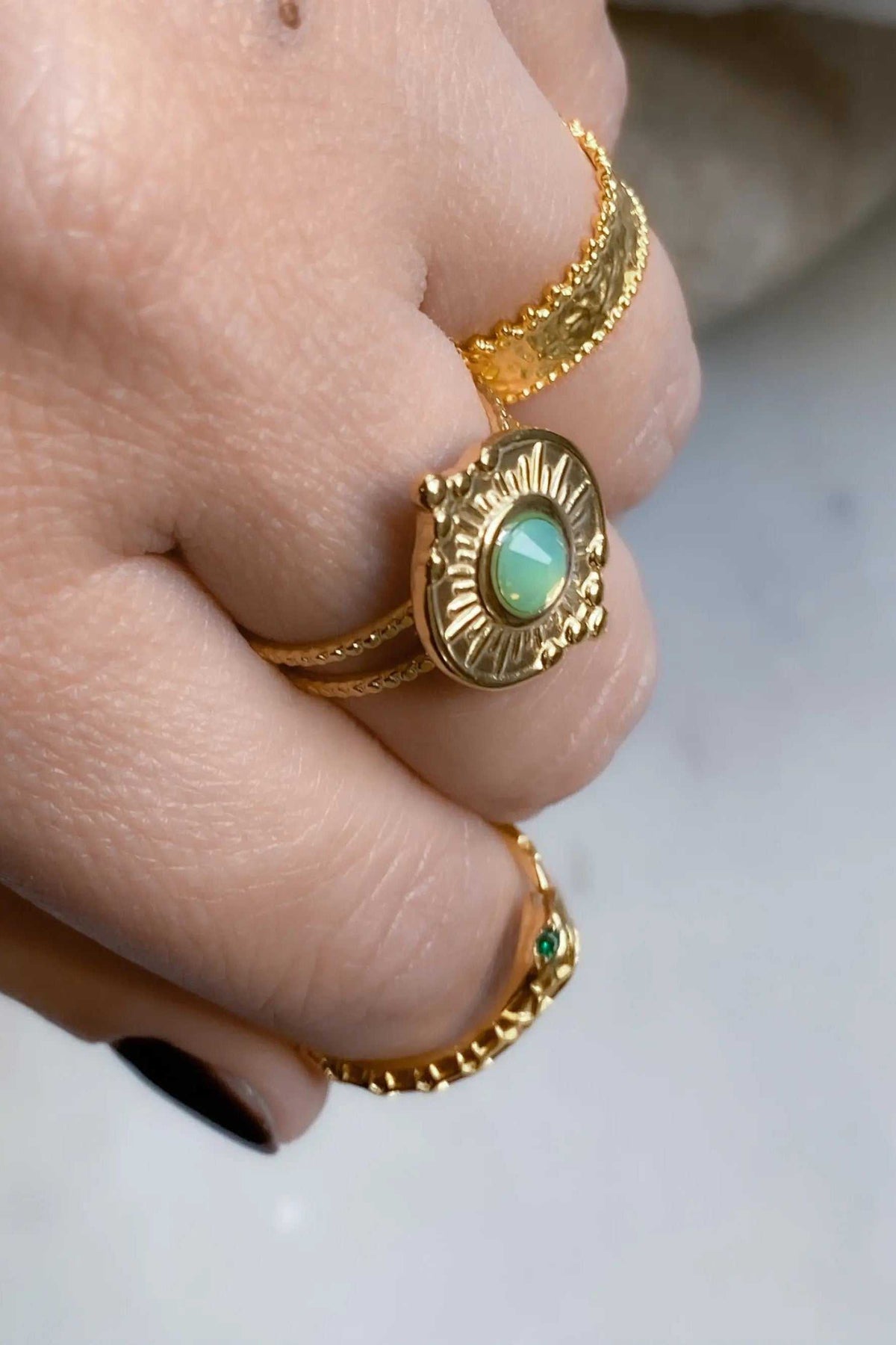 Gold Snake RING with a textured gold-tone serpent band and oval green stone in an ornate raised setting