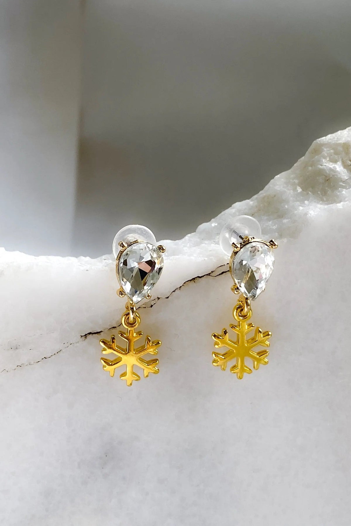 Gold Snowflake Earrings with clear faceted teardrop crystals and dangling polished gold snowflake charms