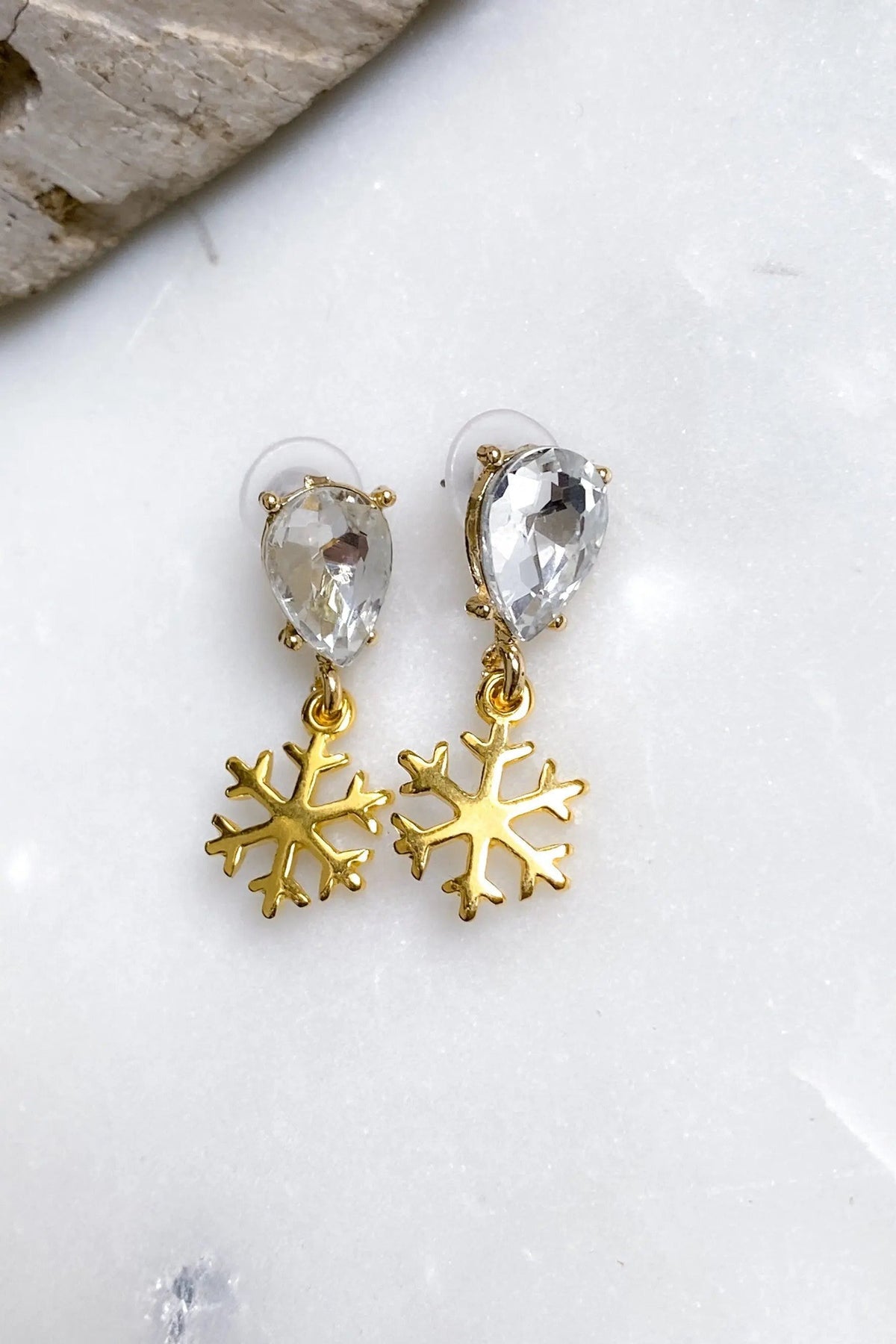 Gold Snowflake Earrings with polished gold-tone snowflake charms and clear faceted teardrop crystals above each charm
