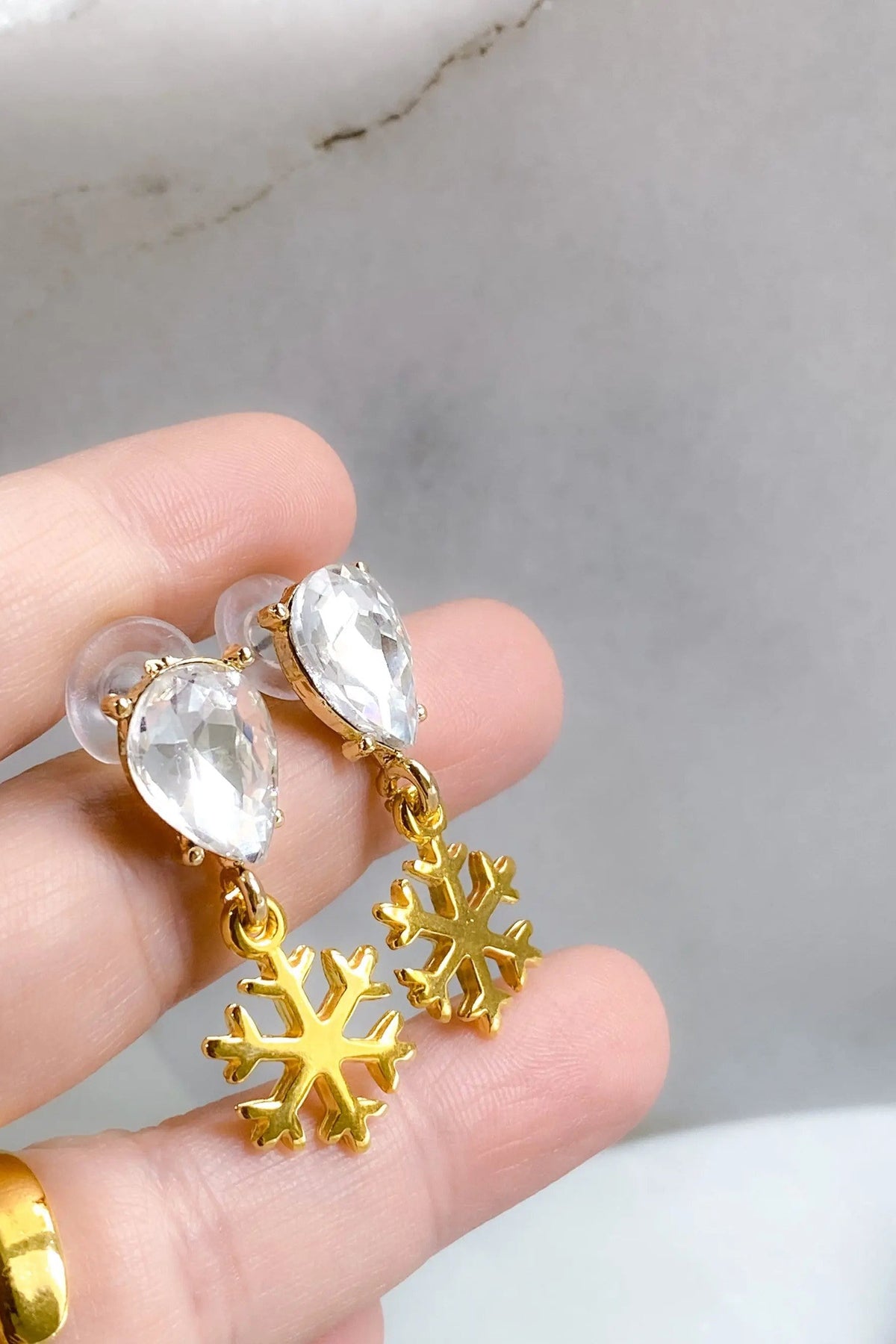 Gold Snowflake Earrings with polished gold-tone snowflake charms and clear faceted teardrop crystals on top