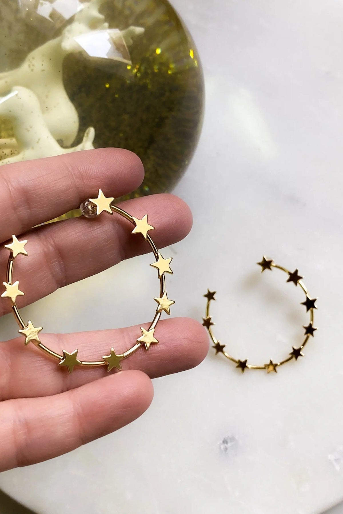 Gold Star Earring hoop with a slim gold-tone metal circle decorated with small five-point star charms