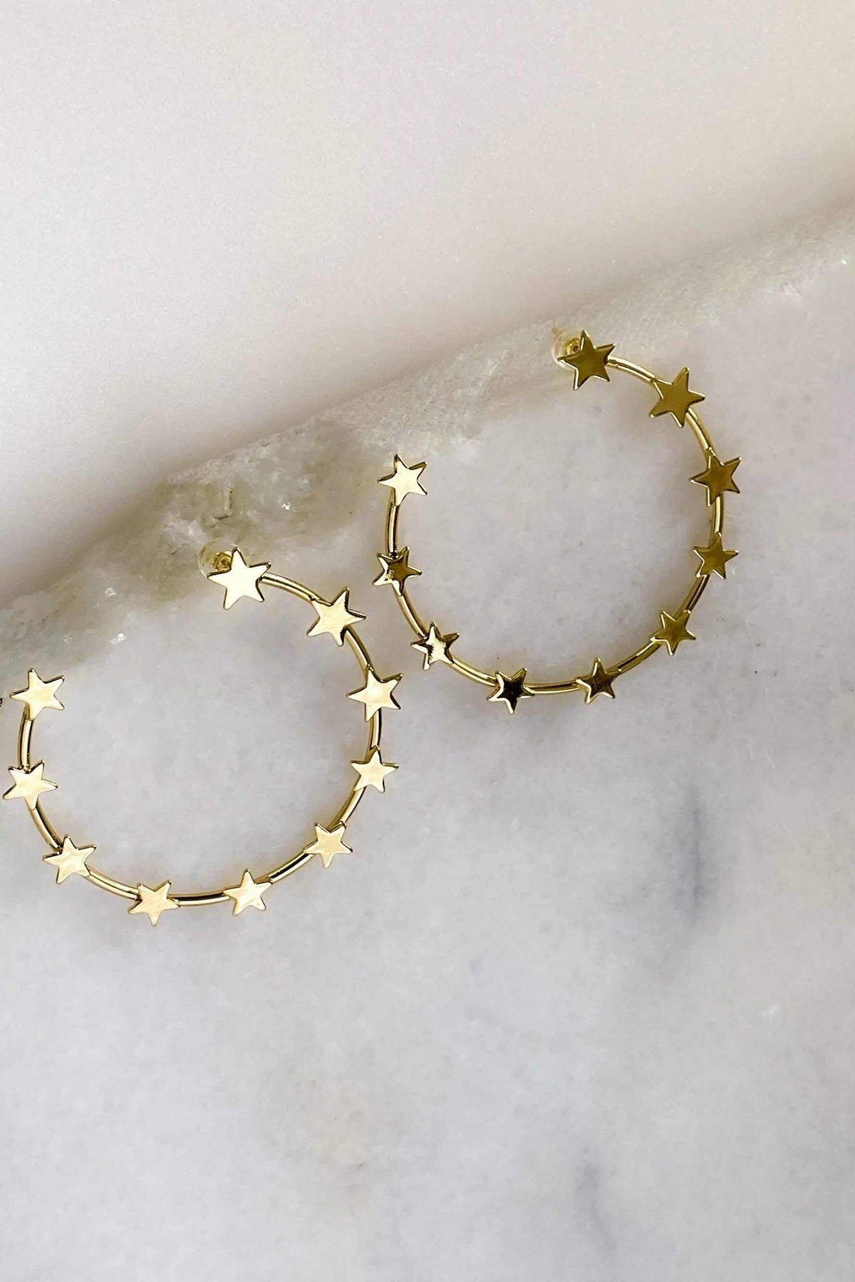 Gold Star Earring hoops in polished gold-tone metal, featuring circular bands decorated with small star charms