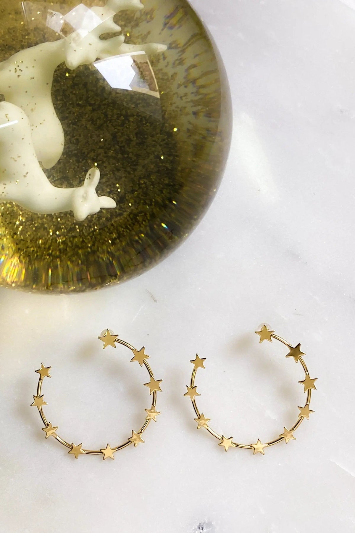 Gold Star Earring hoops in gold-tone metal, with small star charms spaced around open circular hoops