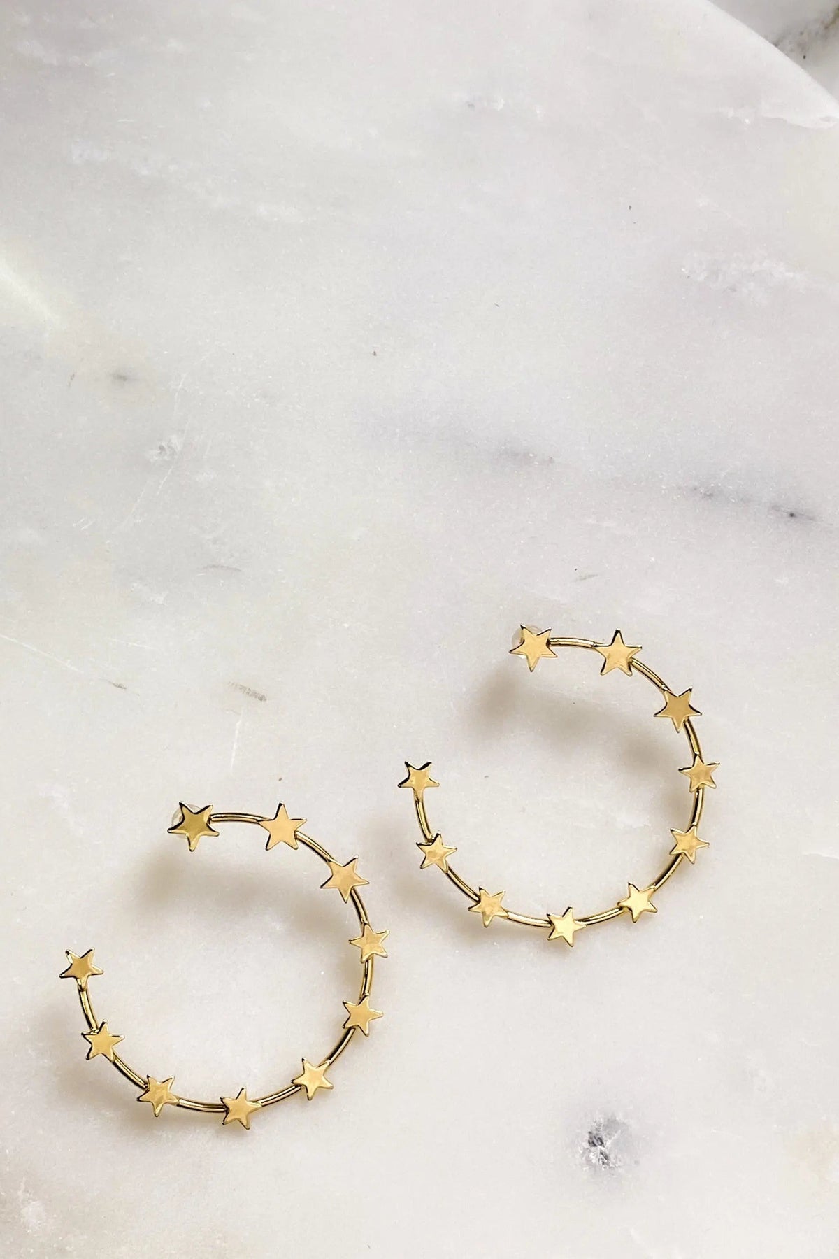 Gold Star Earring hoops in gold-tone metal, formed by a delicate ring of small five-point stars