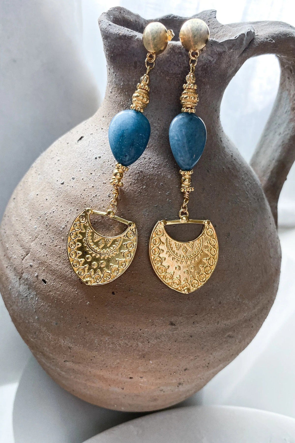 Gold Statement Dangle Earrings with blue oval stones, ornate gold-toned metal drops, and round stud tops