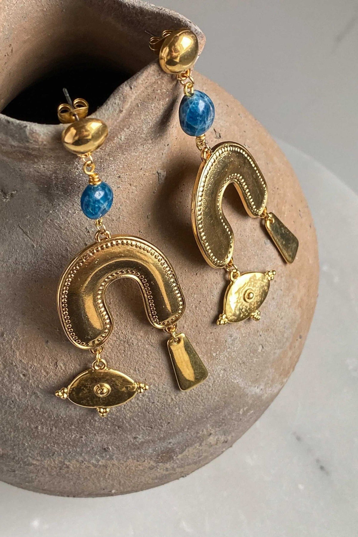 Gold Statement Earrings with blue agate stones, ornate gold-plated brass arches, fish charms and dangling geometric accents