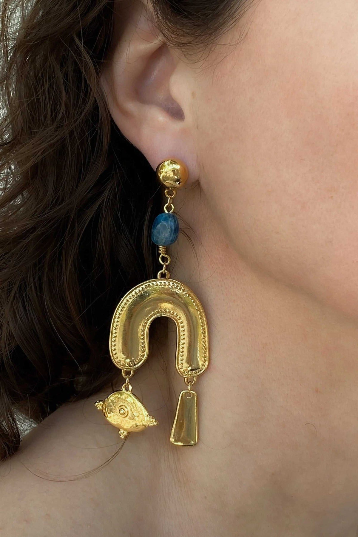 Gold Statement Earrings with blue stone, textured gold-tone arch, dangling fish charm and geometric pendant