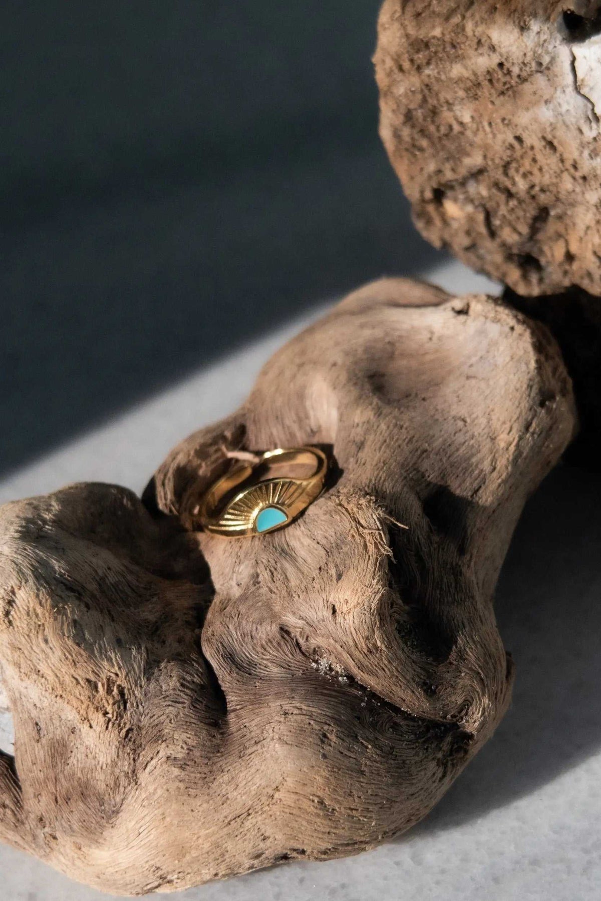 Greek ethnic boho ring in gold-tone metal with a turquoise accent, featuring a sculpted rising sun motif