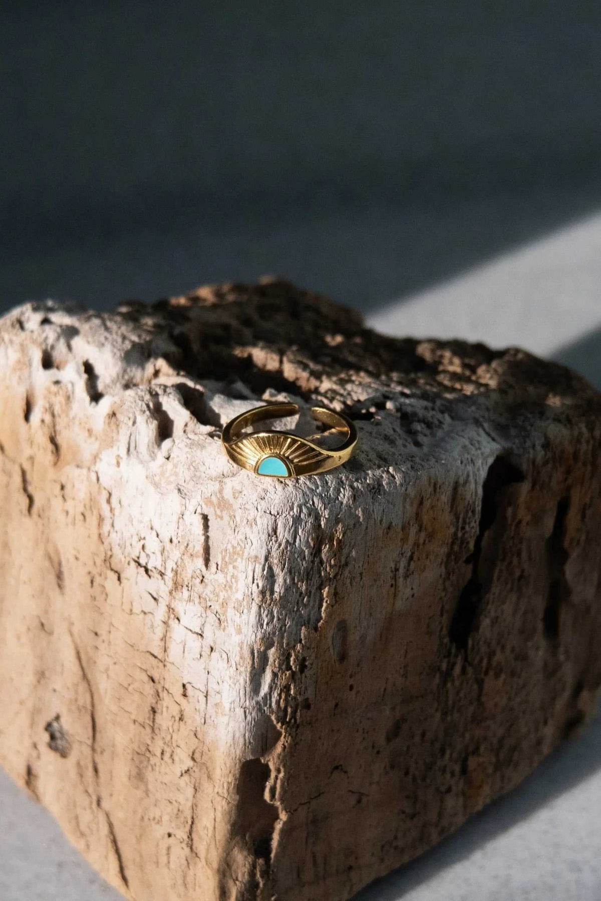 Greek ethnic boho ring in gold-tone metal with a fan-shaped rising sun design and turquoise-colored center stone