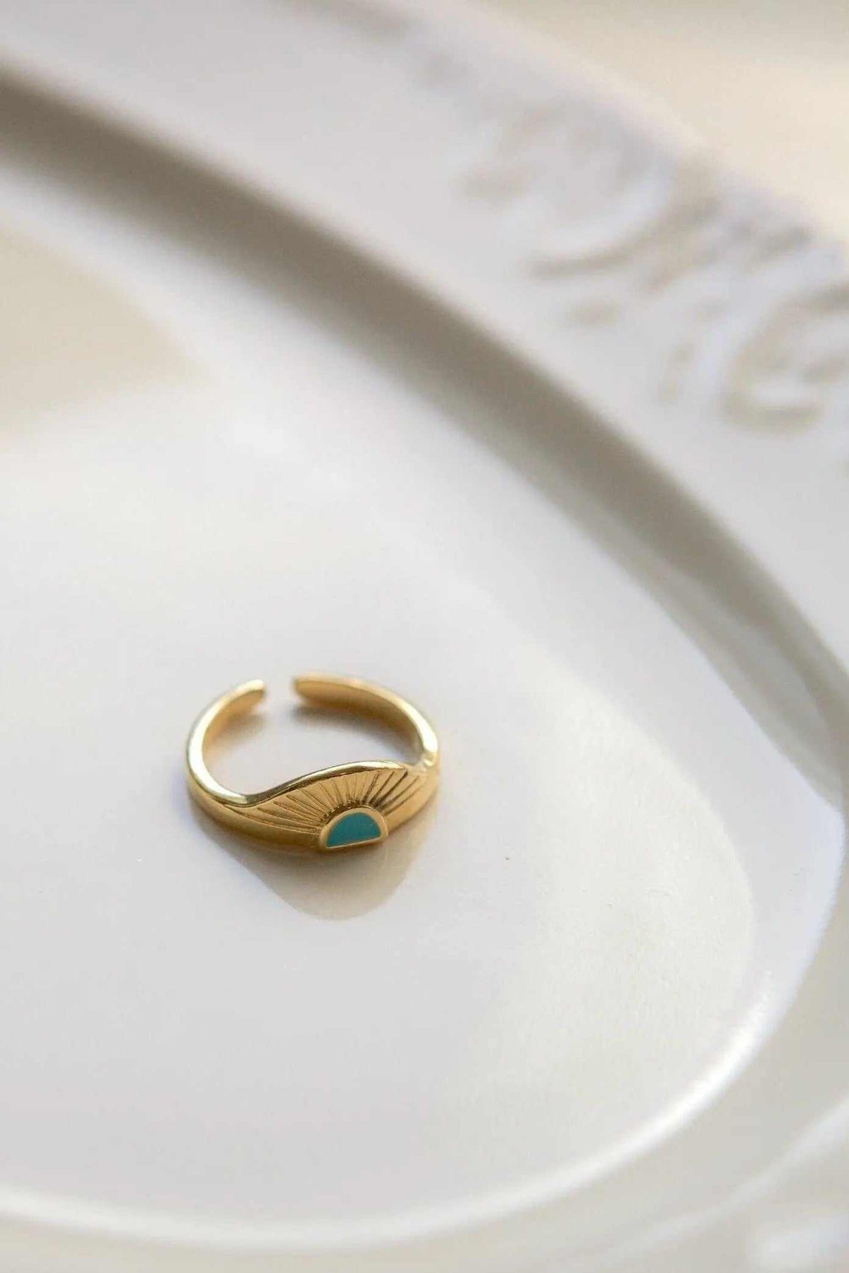 Greek ethnic boho ring in gold tone with an open adjustable band, engraved sunburst rays and a turquoise-colored accent